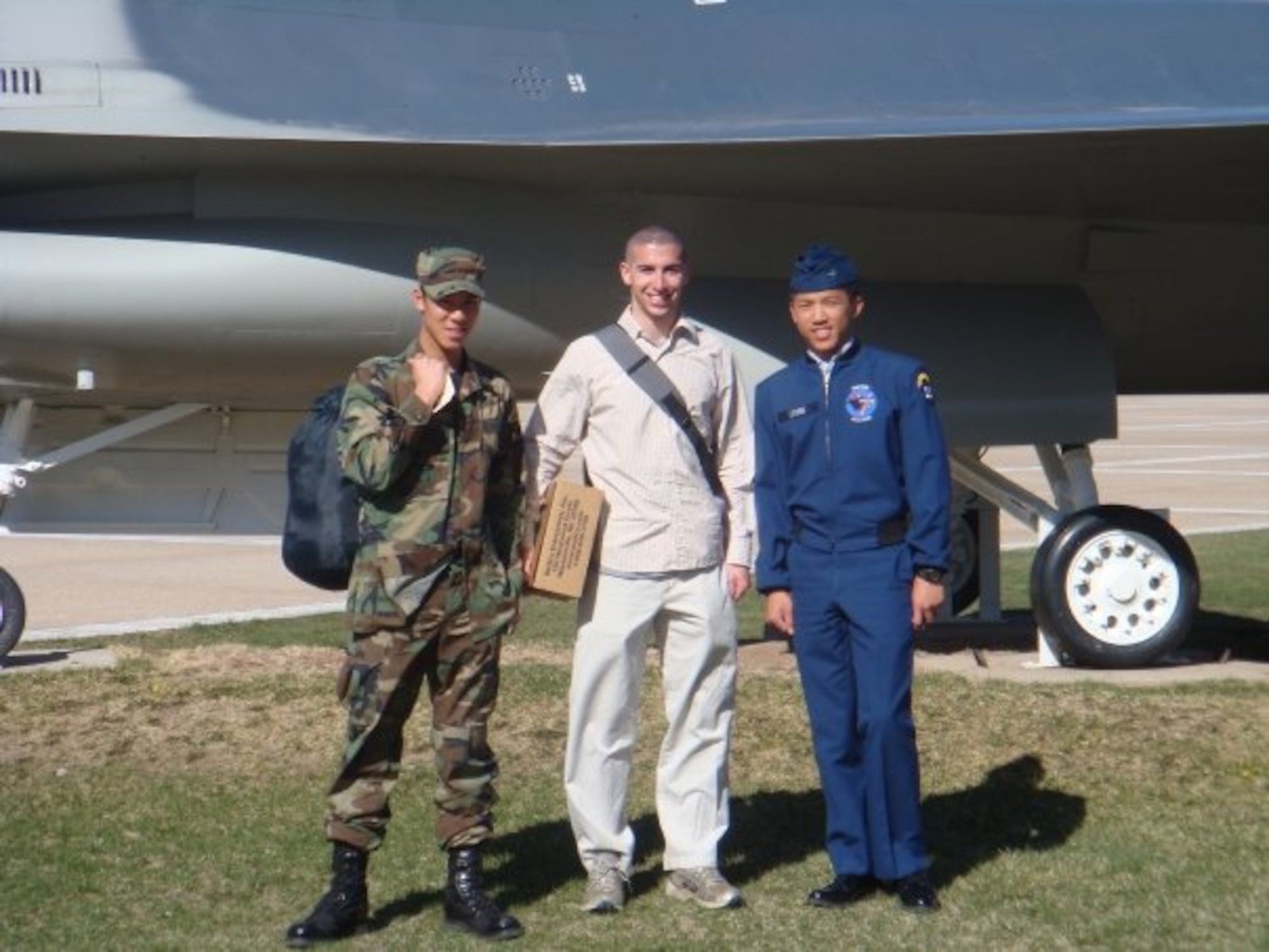 Maj. Chris Ng, 51st Medical Operations Squadron general surgeon, left, and Capt. Louis Bloom, 36th Fighter Squadron F-16 pilot, center, pose in front of an F-16 during the United States Air Force Academy orientation, April, 2008. . Both hailing from Randolph, Massachusetts, the Randolph High School graduates continued their friendship while attending the United States Air Force Academy. Rekindling at Osan Air Base, their familiarization flight plans were initially derailed due to Bloom’s motorcycle accident. Ng’s medical expertise was instrumental to Bloom’s full and speedy recovery during the surgical and rehabilitation process, ultimately resulting in finally flying together. (Courtesy photo)