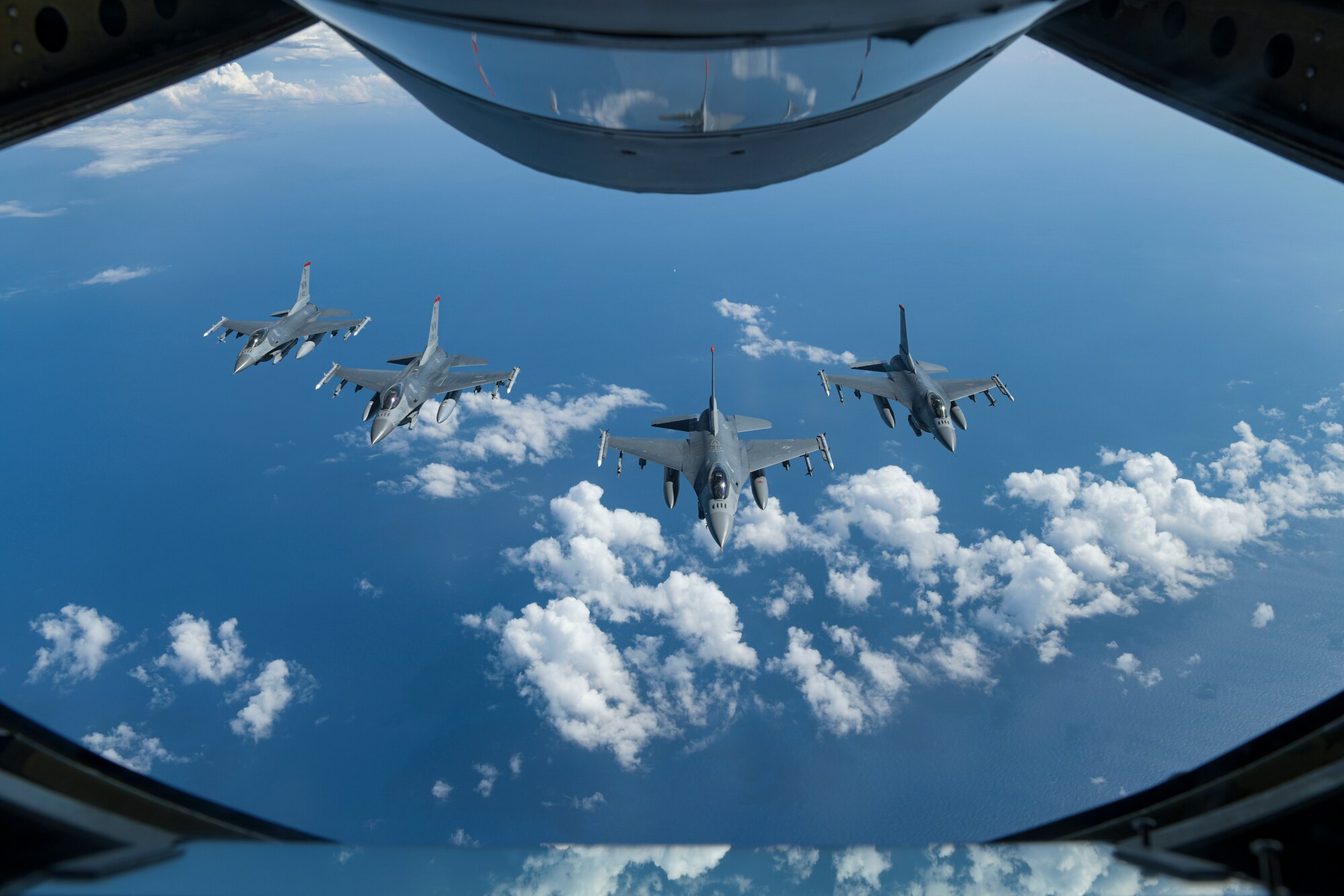 U.S. Air Force F-16 Fighting Falcons from the 35th Fighter Wing, Misawa Air Base, Japan, fly into a four-ship formation under a KC-135 Stratotanker boom pod from the 909th Air Refueling Squadron, July 31, 2020, at Kadena Air Base, Japan. The 18th Wing must be ready to cooperate with regional partners, compete against peer adversaries, and be ready to fight tonight if called upon.