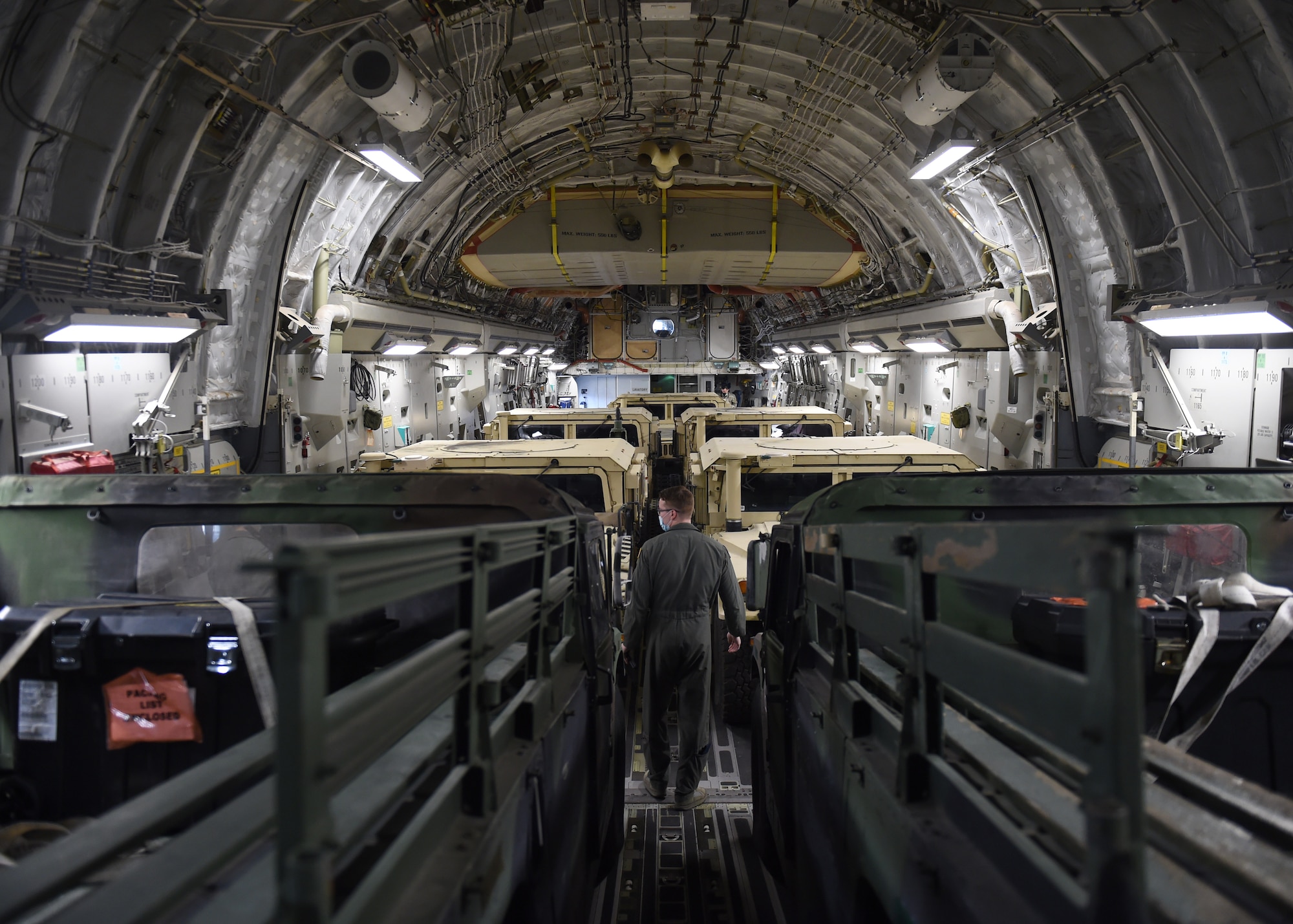 Senior Airman Connor Smith, 4th Airlift Squadron loadmaster, inspects cargo to make sure it is safely secured on a C-17 Globemaster III before taking off from Joint Base Lewis-McChord, Wash., Aug. 5, 2020. The C-17 Globemaster III can carry up to over 160 thousand pounds of cargo. (US Air Force photo by Airman 1st Class Mikayla Heineck)