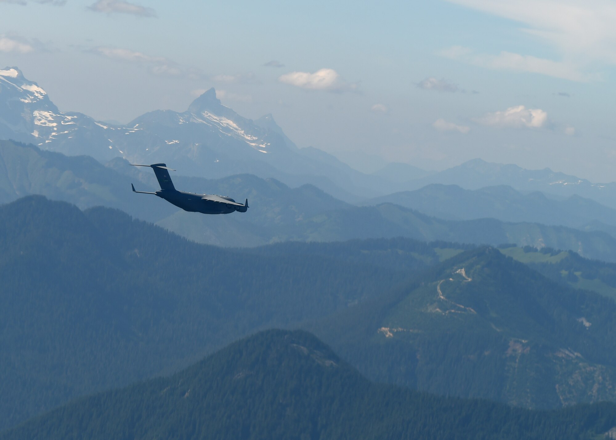 A C-17 Globemaster III from Joint Base Lewis-McChord conducts a low-level formation flight training exercise in central Washington, Aug. 5, 2020. Flying in a formation of two or more aircrafts in a combat scenario allows for tactical advantage by establishing mutual support and mass of aircraft over an objective area.  (U.S. Air Force photo by Airman 1st Class Mikayla Heineck)