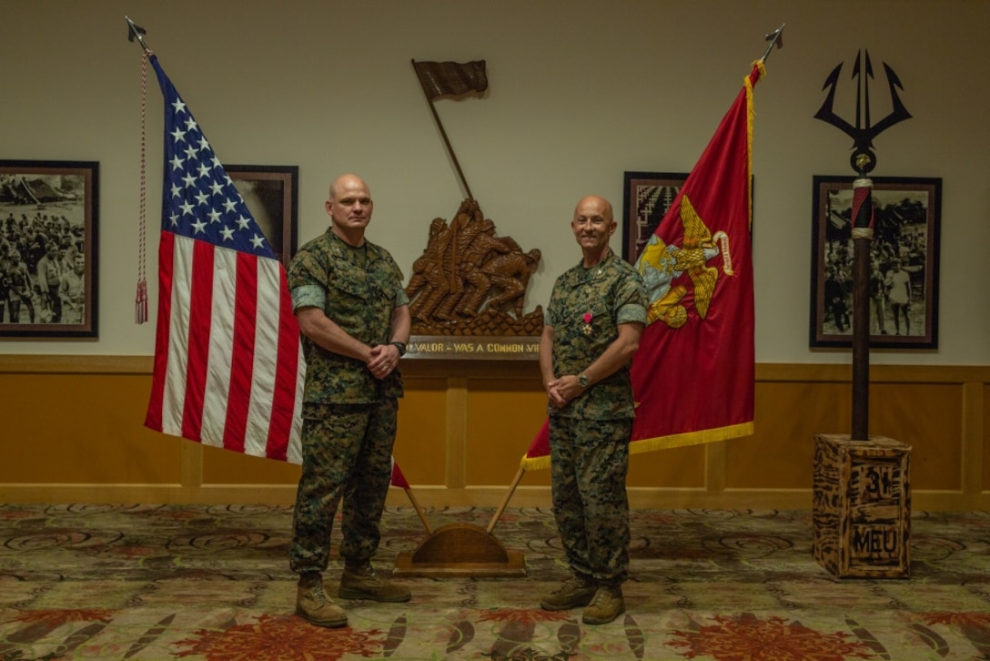 Col. Michael Nakonieczny, left, the oncoming commanding officer of the 31st Marine Expeditionary Unit (MEU) and native of Buena Park, California, and Col. Robert Brodie, the departing commanding officer of the 31st MEU and a native of Bucks County, Pennsylvania, stand in front of the U.S. and unit colors at Camp Hansen, Okinawa, Japan, June 25, 2020. During Brodie’s two years in command of the 31st MEU, the unit completed four full unit-deployment cycles including training, exercises, and real-world operations throughout the Indo-Pacific region. The 31st MEU, the Marine Corps' only continuously forward-deployed MEU, provides a flexible and lethal force ready to perform a wide range of military operations as the premier crisis response force in the Indo-Pacific region. (U.S. Marine Corps photo by Sgt. Audrey M. C. Rampton)