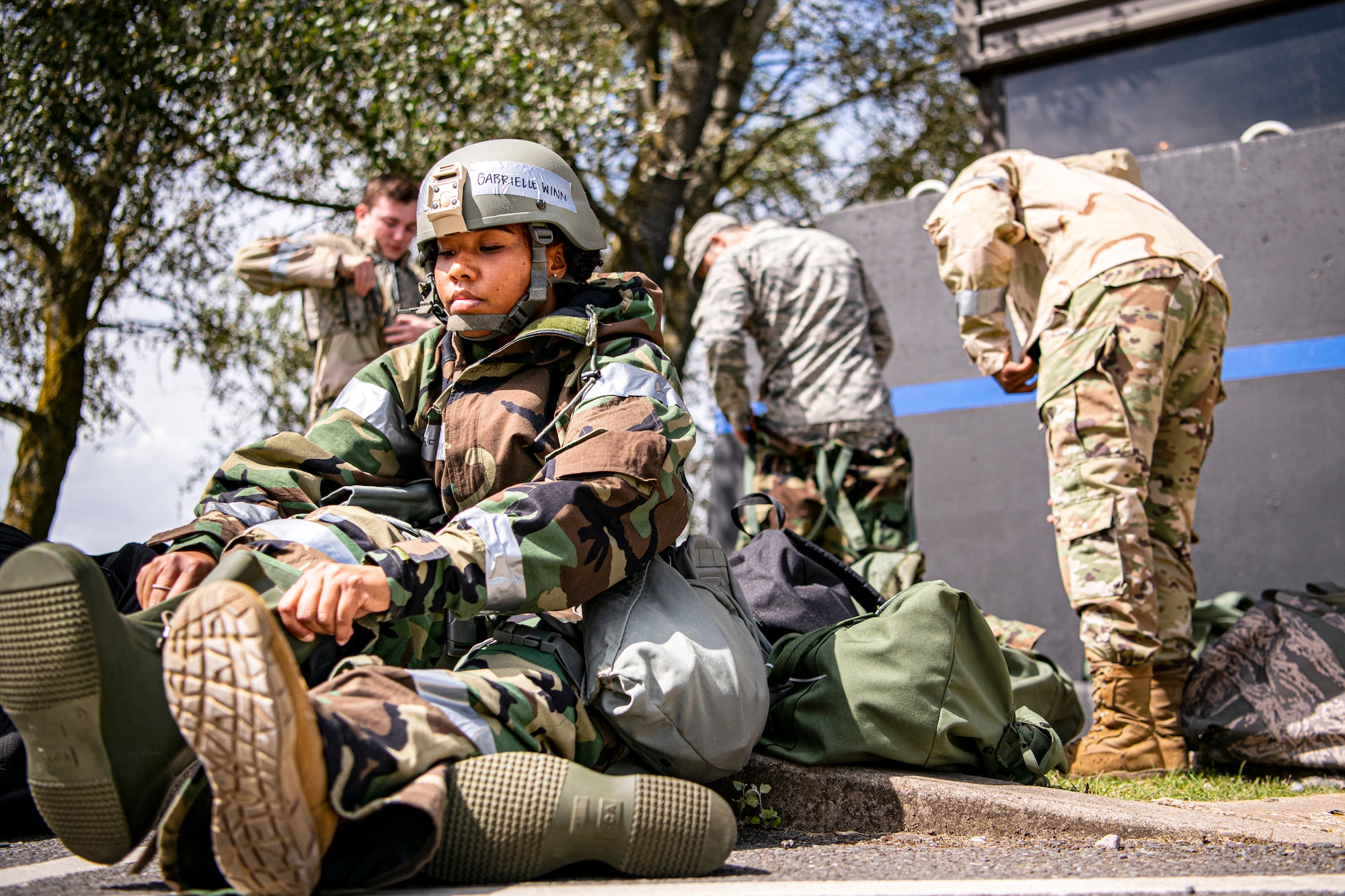 U.S. Air Force Senior Airman Gabrielle Winn, 501st Combat Support Wing (CSW) broadcast journalist, puts on her mission-oriented protective posture gear during a wing readiness exercise at RAF Alconbury, England, Aug. 5, 2020. The 501st CSW conducted the exercise to evaluate Airmen’s overall readiness along with their proficiency with responding to simulated chemical, biological, radiological, nuclear and explosive attacks. (U.S. Air Force photo by Senior Airman Eugene Oliver)