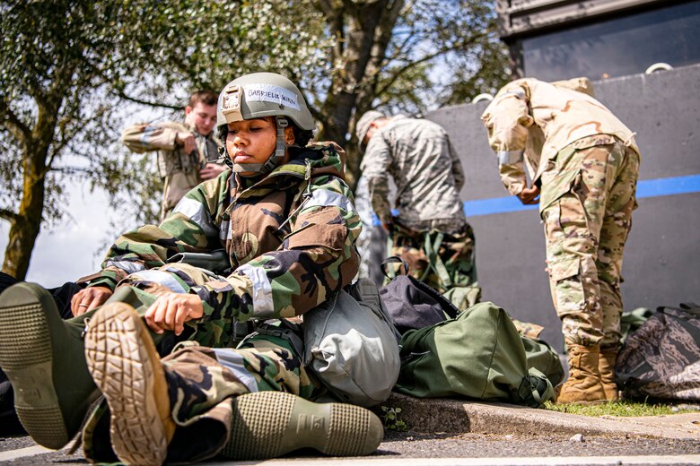 U.S. Air Force Senior Airman Gabrielle Winn, 501st Combat Support Wing (CSW) broadcast journalist, puts on her mission-oriented protective posture gear during a wing readiness exercise at RAF Alconbury, England, Aug. 5, 2020. The 501st CSW conducted the exercise to evaluate Airmen’s overall readiness along with their proficiency with responding to simulated chemical, biological, radiological, nuclear and explosive attacks. (U.S. Air Force photo by Senior Airman Eugene Oliver)
