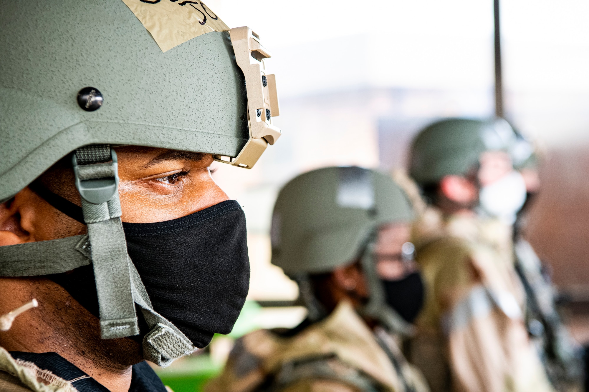 U.S. Air Force Staff Sgt. Thaddeus Johnson, left, 423rd Forces Support Squadron personnelist, stands in formation along with Airmen from the 501st Combat Support Wing during a wing readiness exercise at RAF Alconbury, England, Aug. 5, 2020. The 501st Combat Support Wing conducted the exercise to evaluate Airmen’s overall readiness along with their proficiency with responding to simulated chemical, biological, radiological, nuclear and explosive attacks. (U.S. Air Force photo by Senior Airman Eugene Oliver)