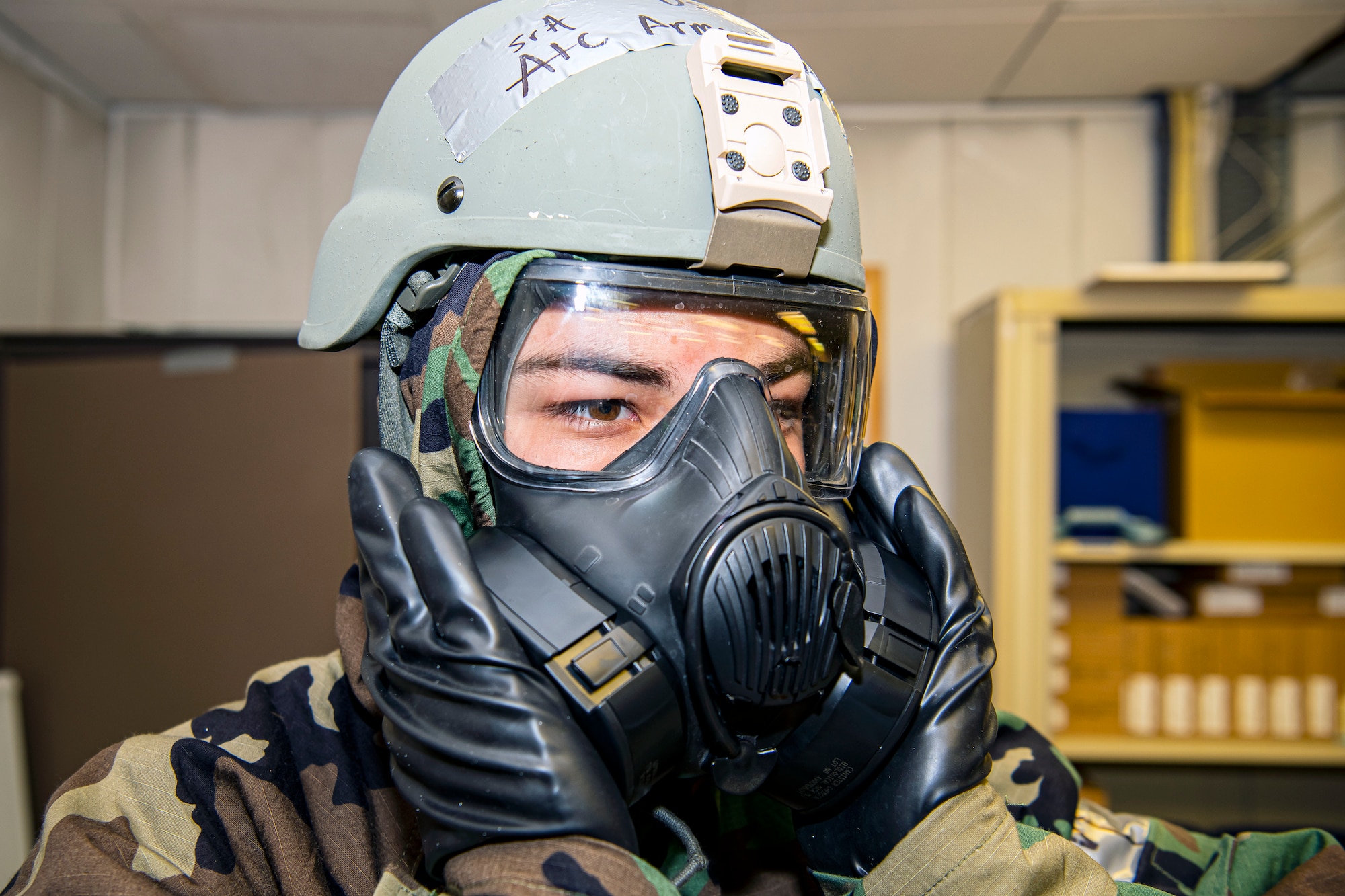 U.S. Air Force Senior Airman William Armenta, 423rd Communications Squadron client systems technician, performs a seal check on his gas mask during a wing readiness exercise at RAF Alconbury, England, Aug. 5, 2020. The 501st Combat Support Wing conducted the exercise to evaluate Airmen’s overall readiness along with their proficiency with responding to simulated chemical, biological, radiological, nuclear and explosive attacks. (U.S. Air Force photo by Senior Airman Eugene Oliver)