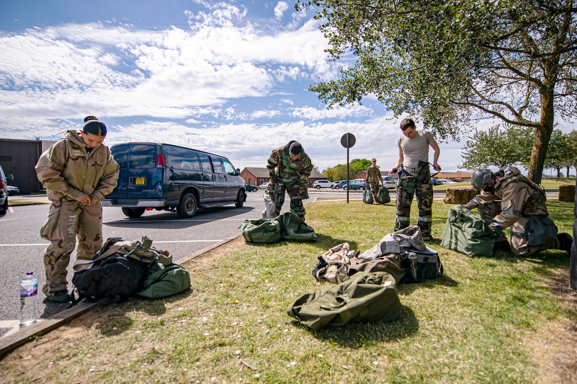 U.S. Air Force Airmen from the 501st Combat Support Wing, put on their mission oriented protective posture gear during a wing readiness exercise at RAF Alconbury, England, Aug. 5, 2020. The 501st CSW conducted the exercise to evaluate Airmen’s overall readiness along with their proficiency with responding to simulated chemical, biological, radiological, nuclear and explosive attacks. (U.S. Air Force photo illustration by Senior Airman Eugene Oliver)