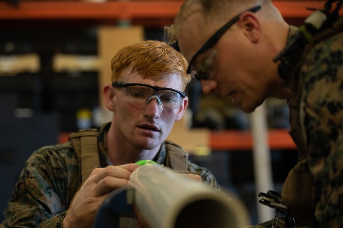 U.S. Marines remove munition from a simulated launcher during the annual East Coast EOD Team of the Year Competition on Marine Corps Base Camp Lejeune, North Carolina, July 23.