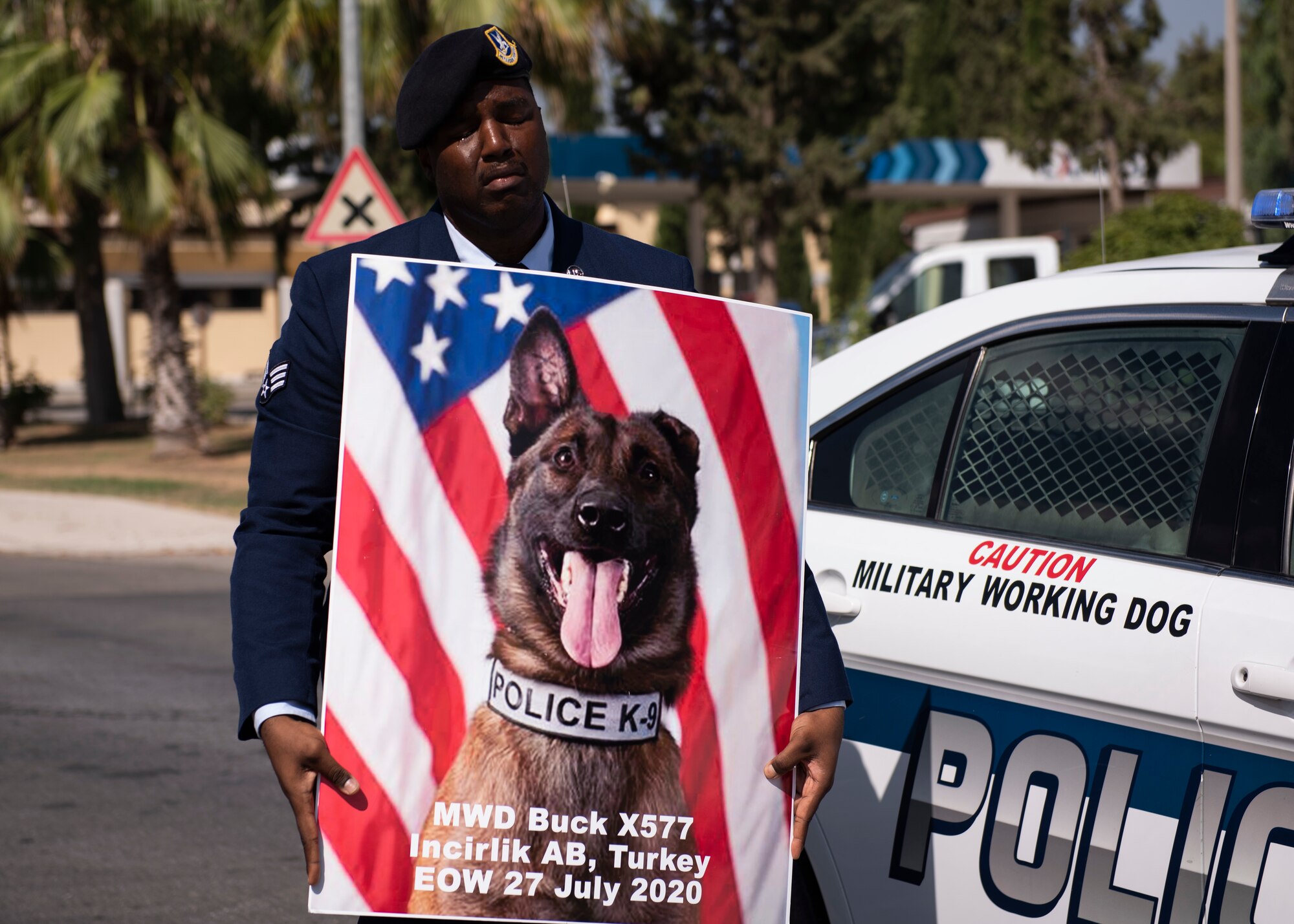 U.S. Senior Airman Antoine Carr, 39th Security Forces Squadron military working dog handler, holds the memorial poster of MWD Buck Aug. 5, 2020, at Incirlik Air Base, Turkey.