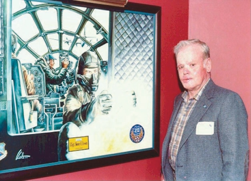 A man stands to the right of a painting depicting action inside an airplane.
