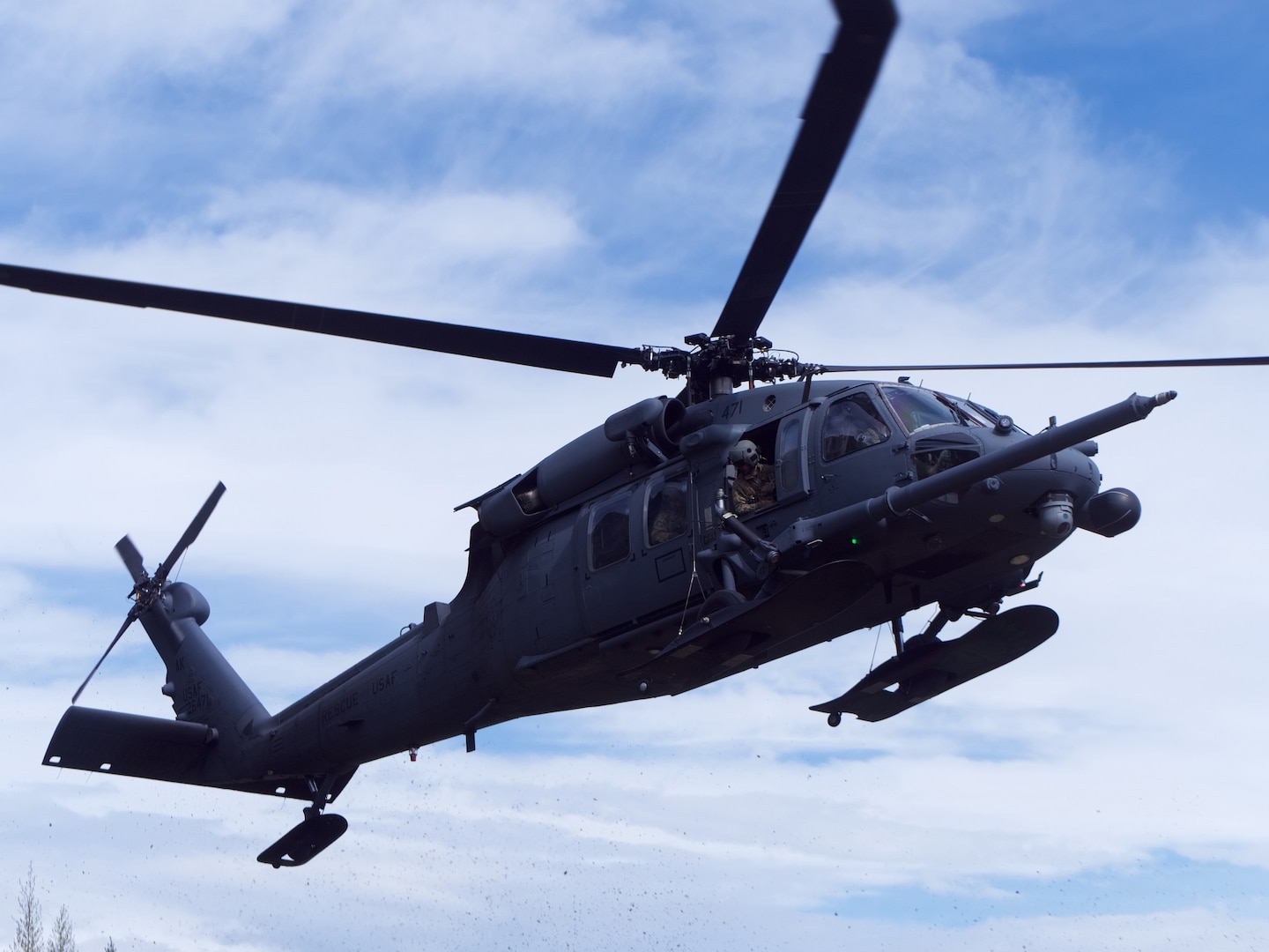 An Alaska National Guard 210th Rescue Squadron HH-60G Pave Hawk conducts hoist training June 5, 2018, at Eklutna Glacier.