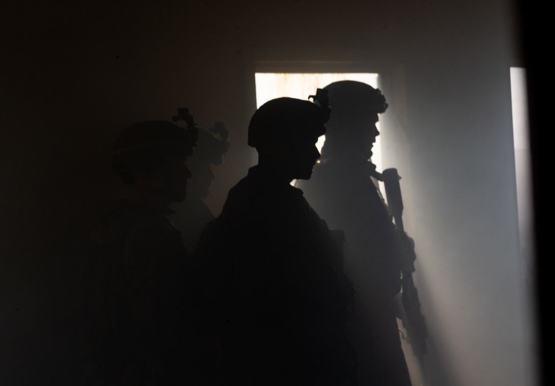 U.S. Marines pass word in a cleared building during Exercise Deep Water on Camp Lejeune, N.C., Aug. 1.