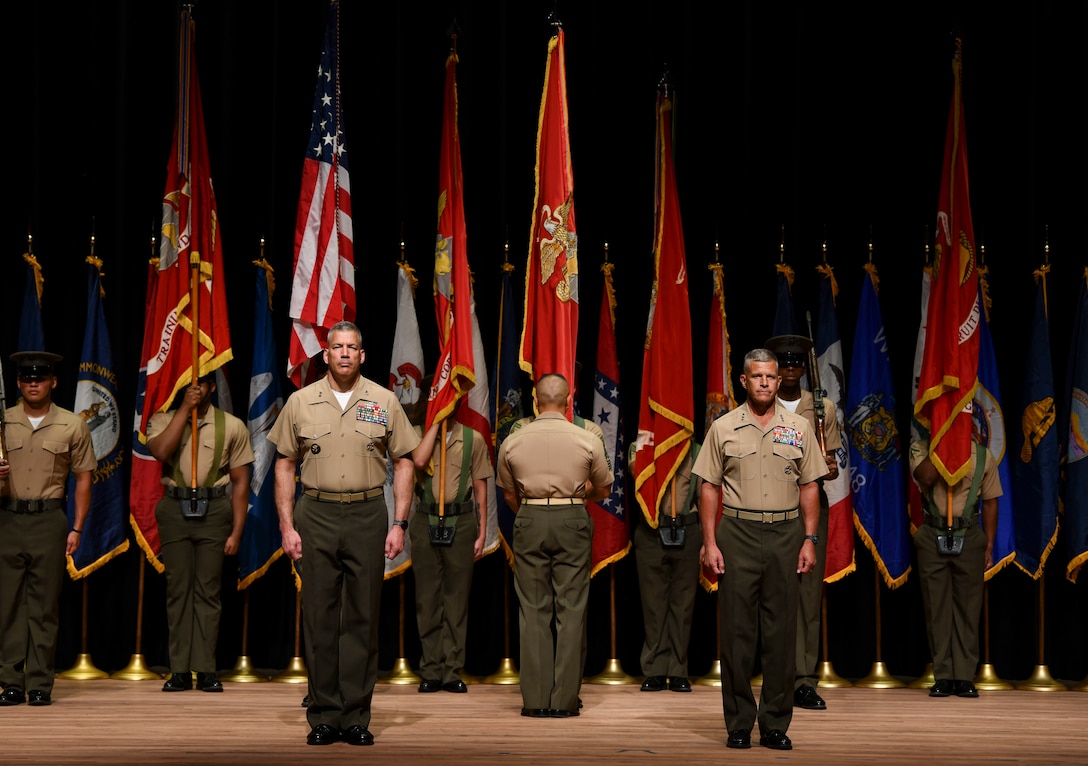 A U.S. Marine receives the colors during the change of command ceremony for Training and Education Command at Warner Hall, Marine Corps Base Quantico, Va., Aug. 3.