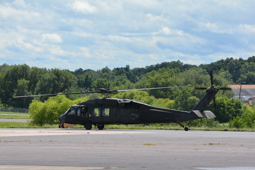 Staff Sgt. Noah McElory looks out the window of the UH-60 Black Hawk containing the Pennsylvania Helicopter Aquatic Rescue Team as it takes off from Muir Army Airfield, Fort Indiantown Gap, Pa., on Aug. 4, 2020. The team saved two motorists from rising flood waters during Tropical Storm Isaias.