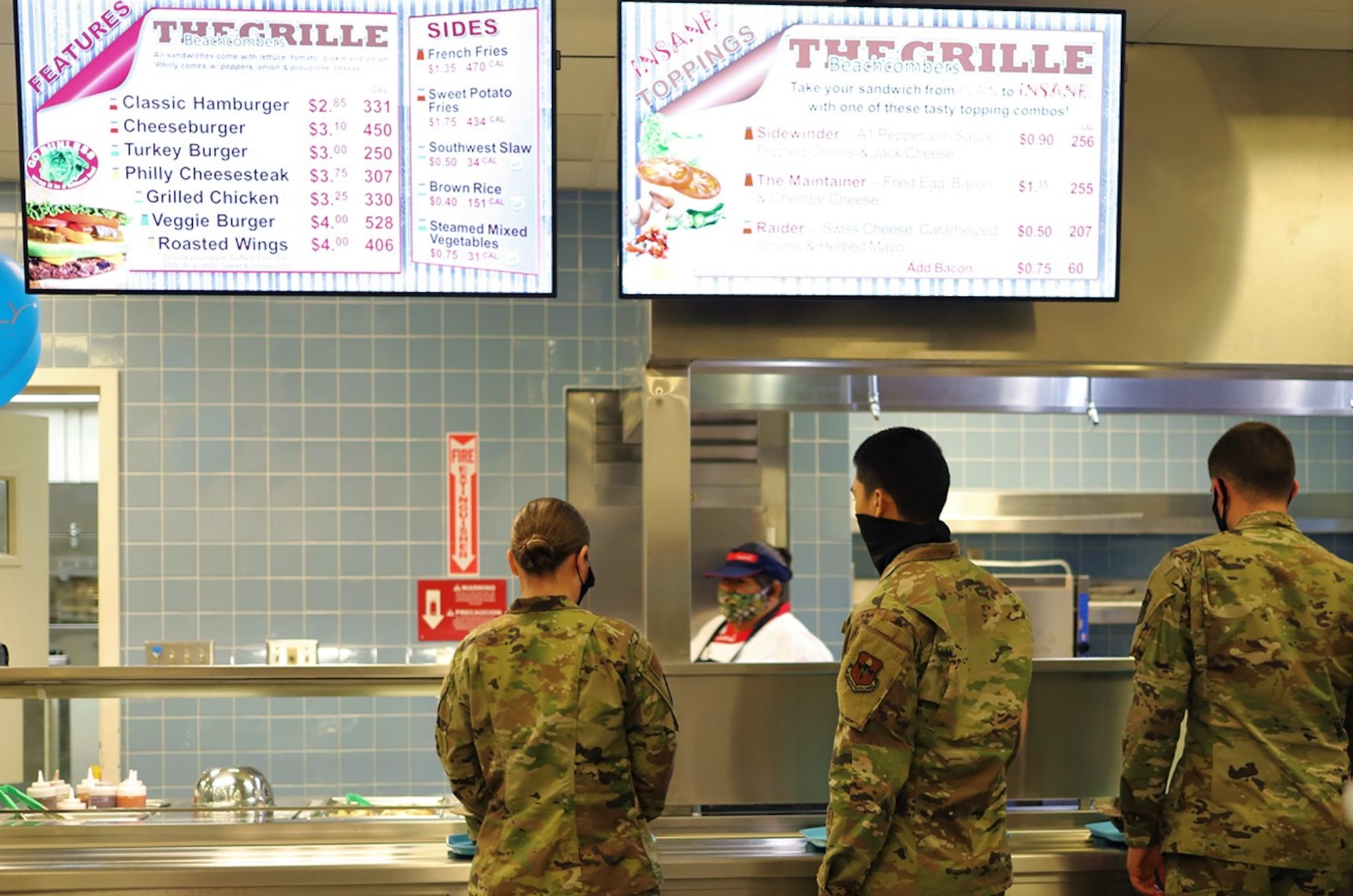 Students line up for lunch at the grille station inside the newly reopened The Beachcombers dining facility at Vandenberg AFB, California, Aug. 6, 2020.