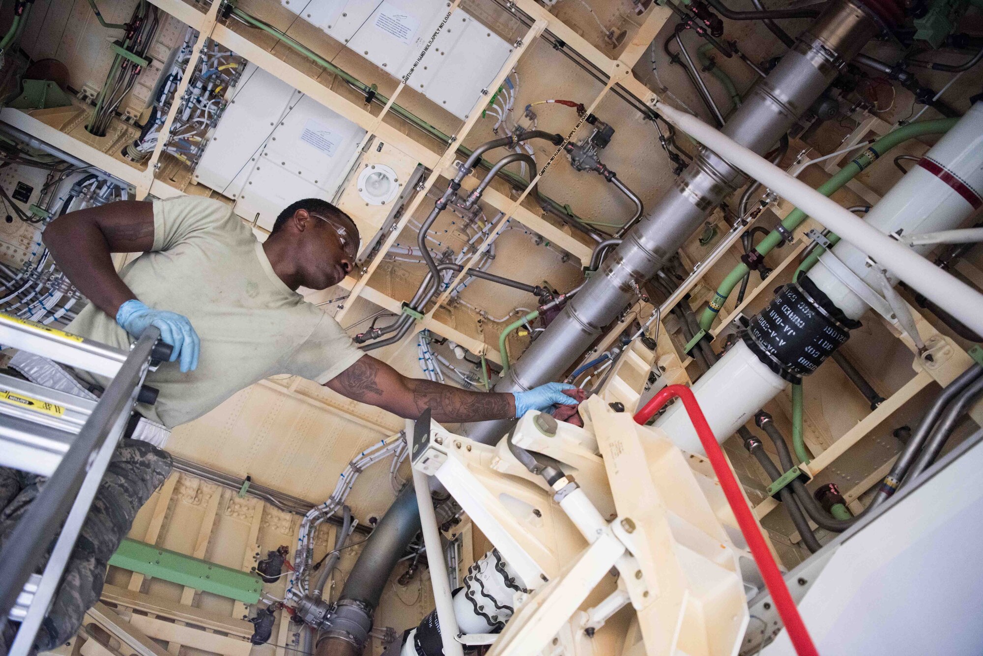 Airman 1st Class Jonethen Strickland, 22nd Maintenance Squadron crew chief, lubricates the main landing gear door Aug. 3, 2020, at McConnell Air Force Base, Kansas. Maintenance Airmen are responsible for the maintenance of McConnell’s 24 KC-46 aircraft to keep them mission ready at all times. (U.S. Air Force photo by Senior Airman Alexi Bosarge)