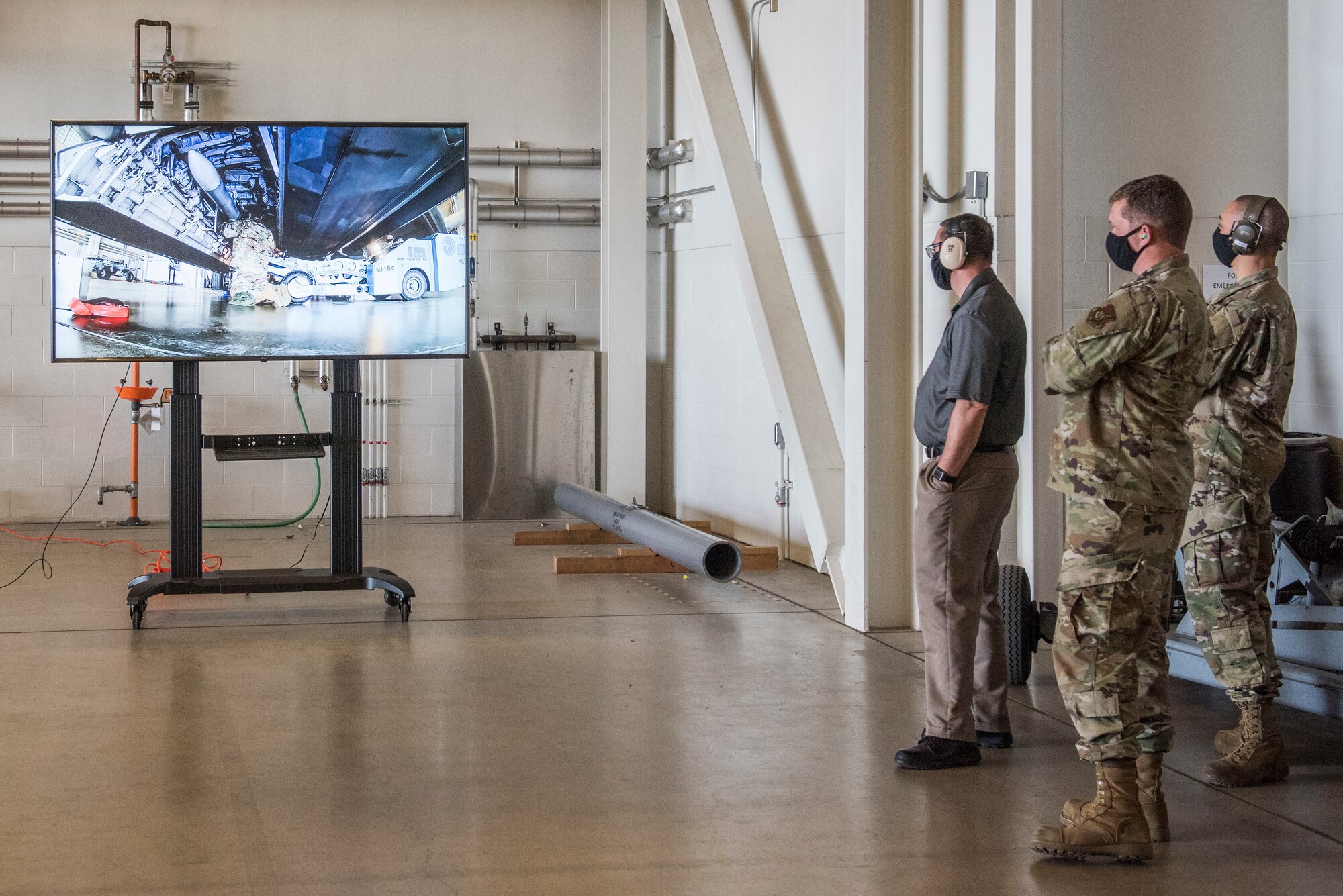 Joint Base Elmendorf-Richardson members watch a live viewing of an F-22 Raptor bay loading operation during the 2nd Quarterly Wing Load Crew competition at JBER, Alaska, July 31, 2020. The live viewing is a new addition to the competition in order to provide audience members with an unobstructed view of the event.