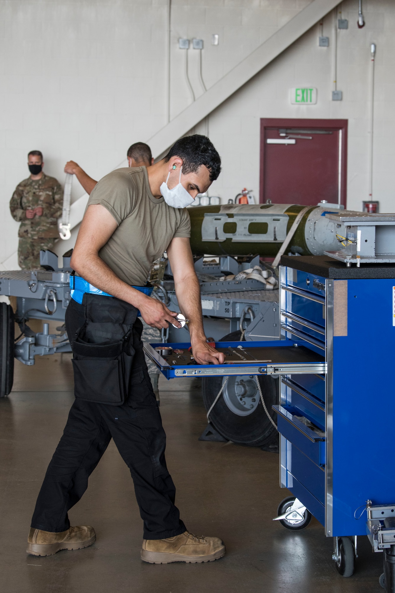 U.S. Air Force Airmen 1st Class Christian Cortez, 525th Aircraft Maintenance Unit weapons load crew member, grabs tools in preparation for the 2nd Quarterly Wing Load Crew competition, at Joint Base Elmendorf-Richardson, Alaska, July 31, 2020. The event consisted of the 90th AMU and 525th AMU testing their technical expertise with a basic knowledge test, composite tool kit inspection, uniform inspection, and F-22 weapons load out.