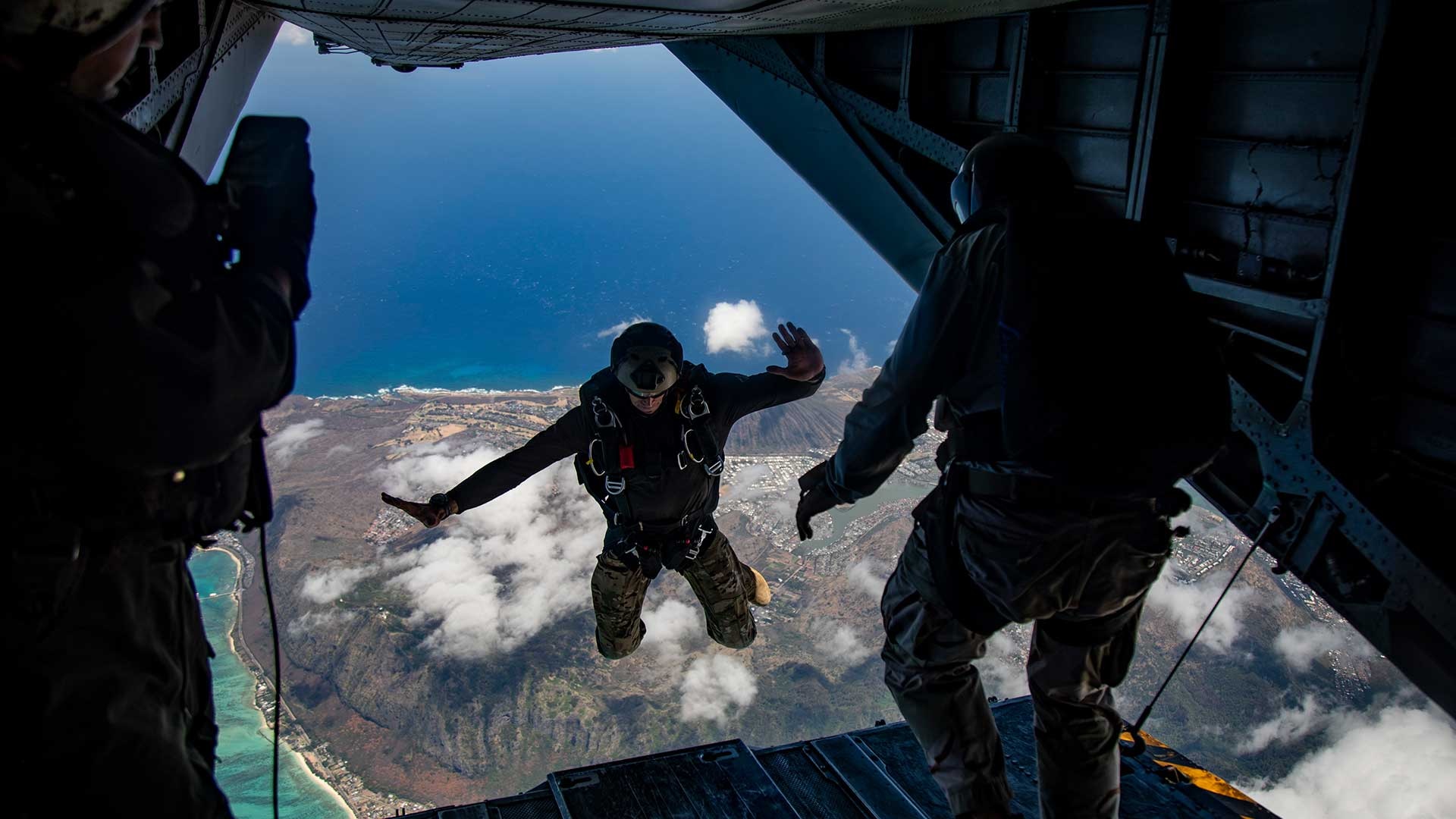 A U.S. Service member with Special Operations Command, Pacific, jumps out of a CH-53E Super Stallion during parachute operations, Marine Corps Training Area Bellows, Marine Corps Base Hawaii, June 19, 2019.