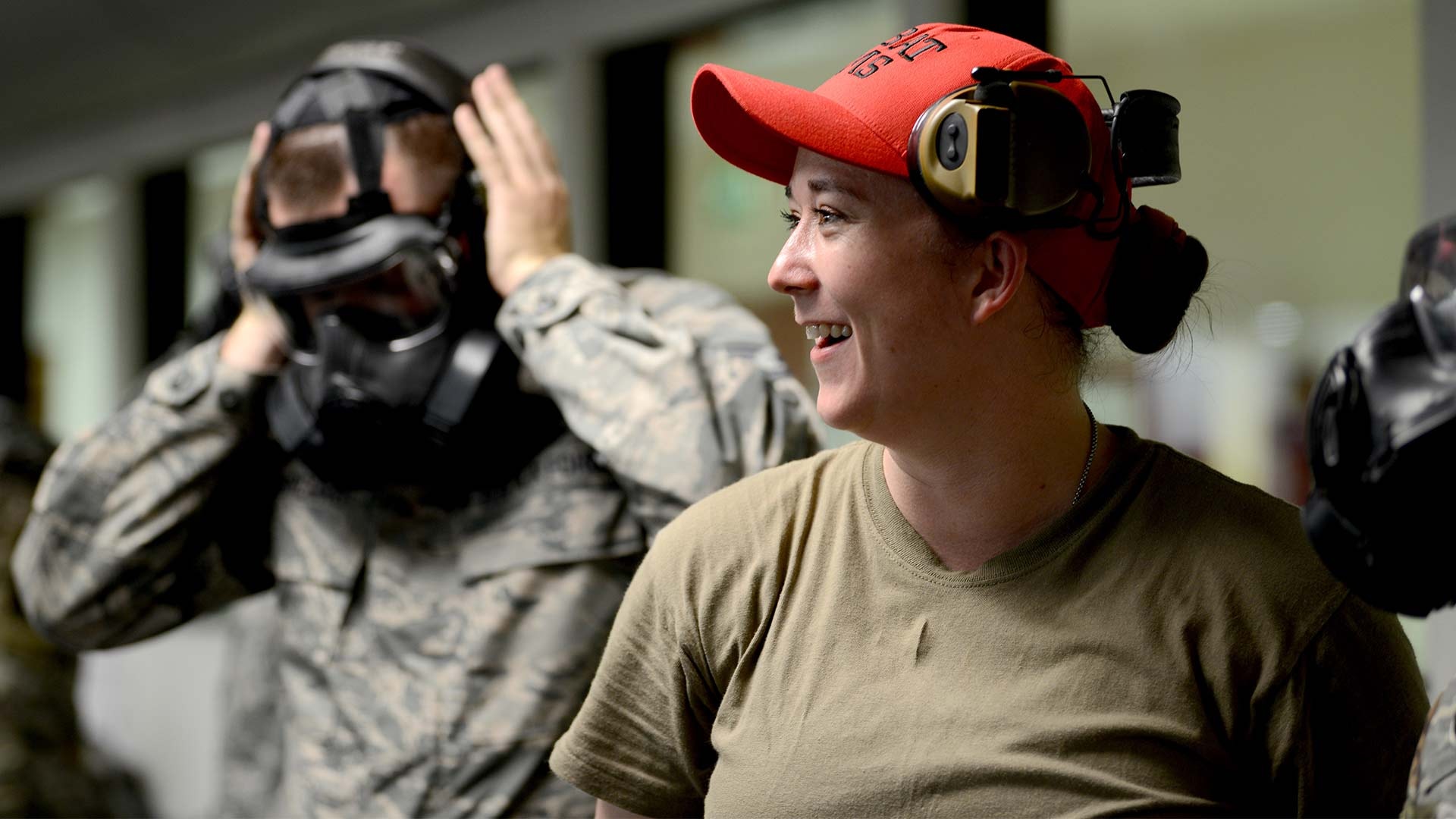 Staff Sgt. Brandee Hahn, combat arms instructor from the 31st Security Forces Squadron, at Aviano Air Base, Italy, teaches an Air Force Qualification Course at Aviano’s indoor firing range, June 20