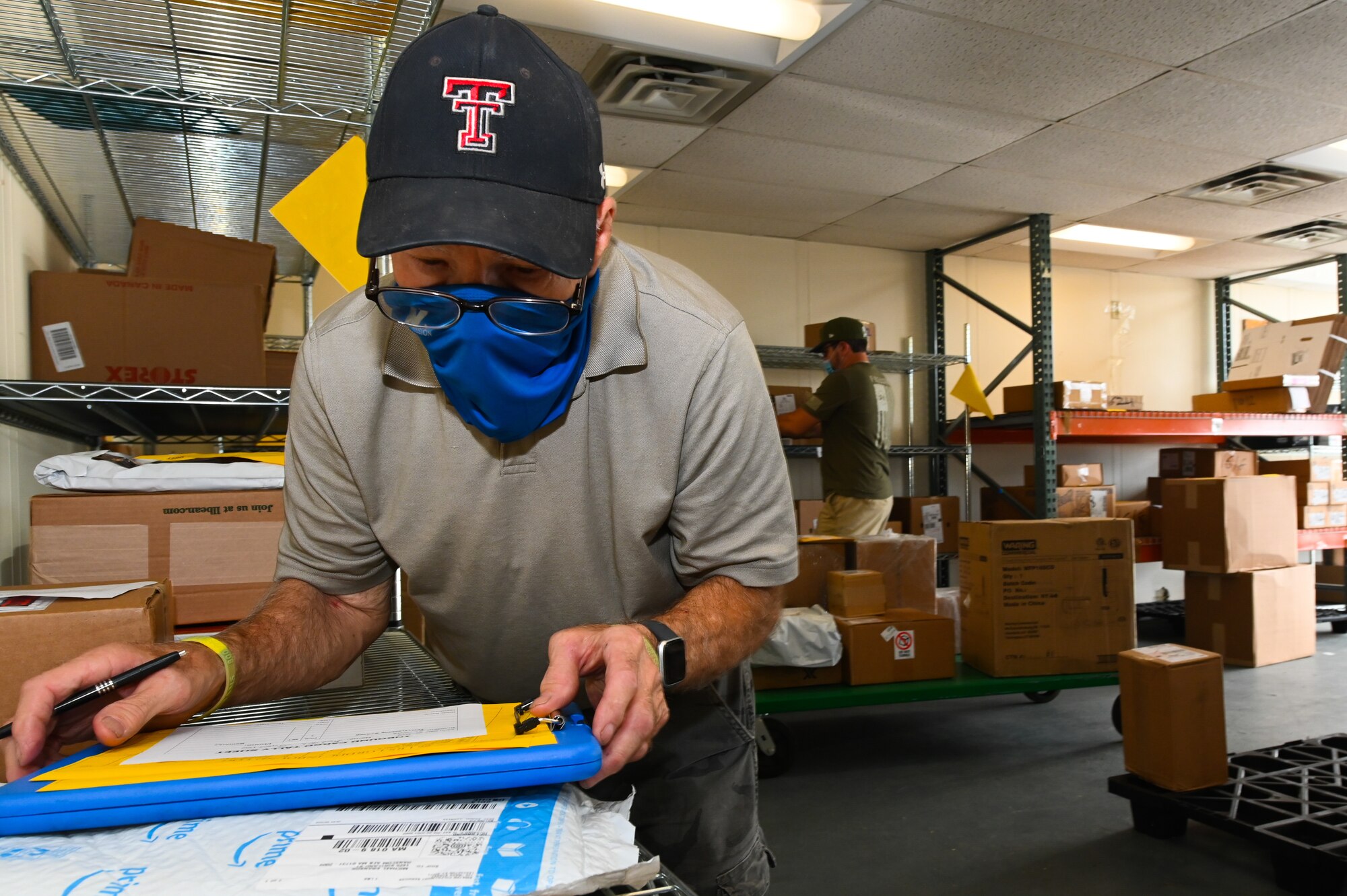 John Juppe, left, 66th Logistics Readiness Squadron cargo specialist, and Derek Matte, 66 LRS freight rate specialist, inspect packages ready for pickup at the 66 LRS Shipping and Receiving warehouse on Hanscom Air Force Base, Mass., Aug. 6. The warehouse will increase hours to Monday, Tuesday and Thursday, from 8 a.m. to 4 p.m., to allow customers to pick up shipments beginning Aug. 10. (U.S. Air Force photo by Todd Maki)