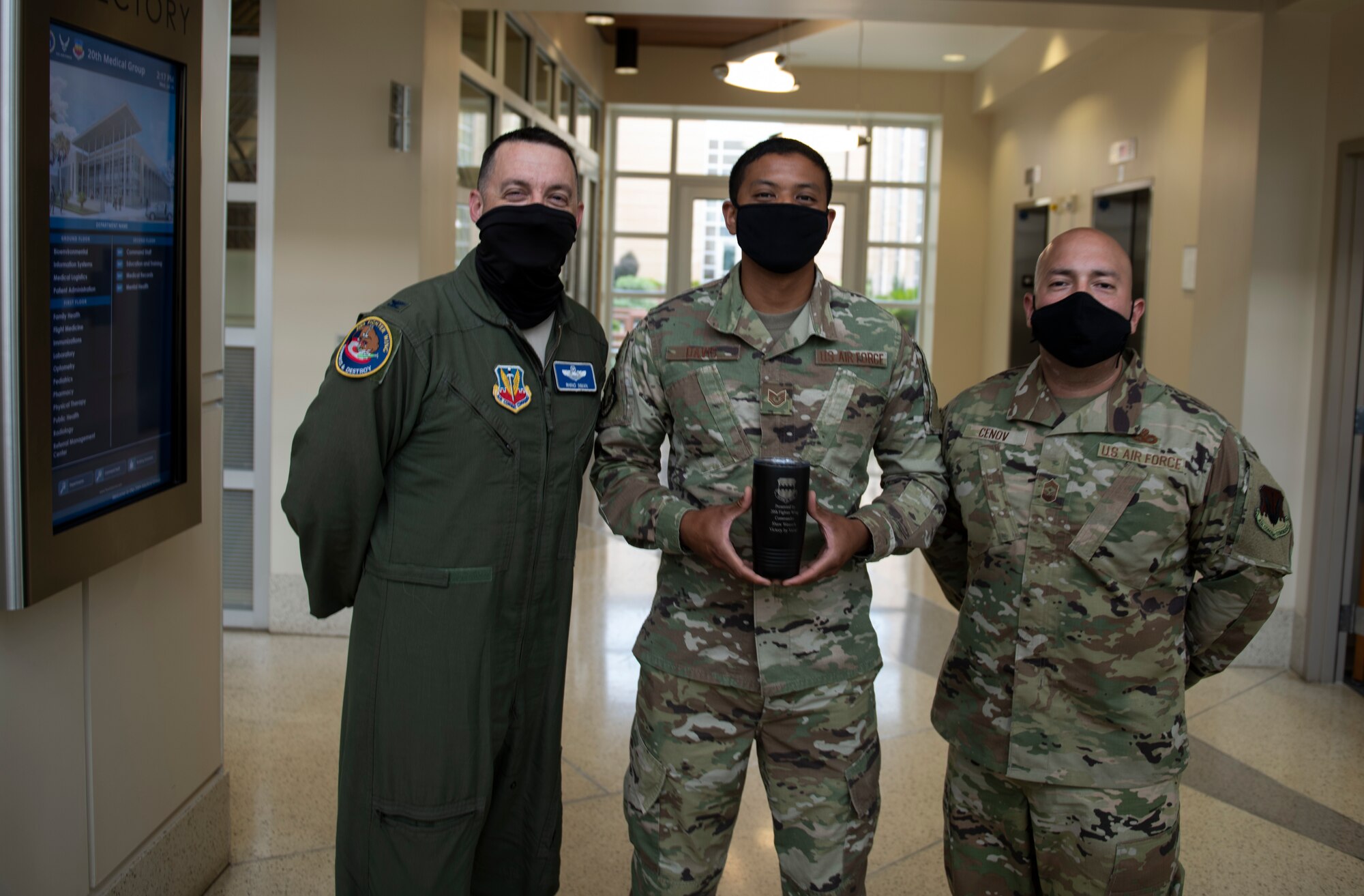 Image of an Airman accepting a Weasel of the Week award.