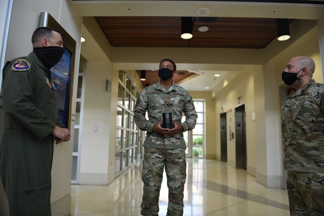 U.S. Air Force Col. Ryan Inman, 20th Fighter Wing (FW) vice commander, left, Tech Sgt. Marcos Charles Davis, 20th Medical Group physical therapy flight chief, middle, and Chief Master Sgt. Steve Cenov, 20th FW command chief, discuss the work ethic required to become Weasel of the Week, at Shaw Air Force Base, South Carolina, July 29, 2020.