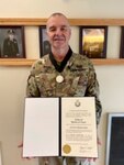 West Virginia Army National Guard Chaplain (Lt. Col.) Michael Allen holds his U.S. Army Order of St. Martin of Tours Chaplaincy Award Aug. 5, 2020. Allen was given this award for his service as Installation Directorate Training chaplain at Fort Eustis, Virginia, from August 2019 to May 2020. (Courtesy photo)