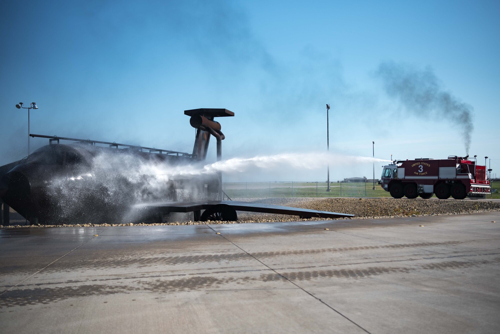 Airman 1st Class Jeff Farrell, 22nd Civil Engineer Squadron fire protection apprentice, uses an aerospace protection aircraft rescue firetruck to put out a simulated fire Aug. 4, 2020, at McConnell Air Force Base, Kansas. The fire department conducts weekly ladder and structural firefighting training for all members and required to conduct at least two aircraft and structured burn training annually. (U.S. Air Force photo by Senior Airman Alexi Bosarge)