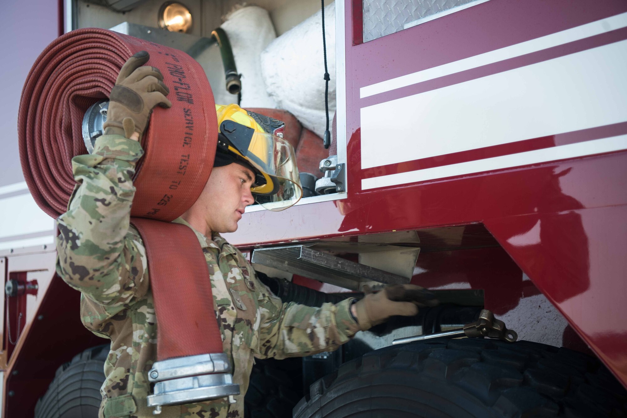 Airman 1st Class Jeff Farrell, 22nd Civil Engineer Squadron fire protection apprentice, prepares to refill the water tank on an aerospace protection aircraft rescue firetruck Aug. 4, 2020, at McConnell Air Force Base, Kansas. The large diameter supply hose that Farrell used is 50 feet long allowing him to fill the AP-23 ARFF truck which can hold up to 3,300 gallons of water. (U.S. Air Force photo by Senior Airman Alexi Bosarge)