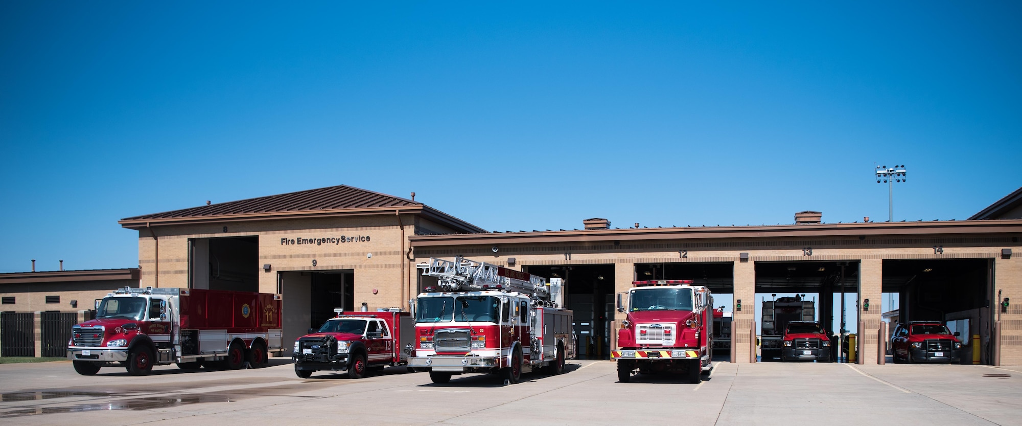 Firetrucks await an emergency call outside Fire Station 1 Aug. 4, 2020, at McConnell Air Force Base, Kansas. McConnell’s fire department is staffed with 15 firefighters at all times to ensure that all of Team McConnell is safe 24/7. (U.S. Air Force photo by Senior Airman Alexi Bosarge)