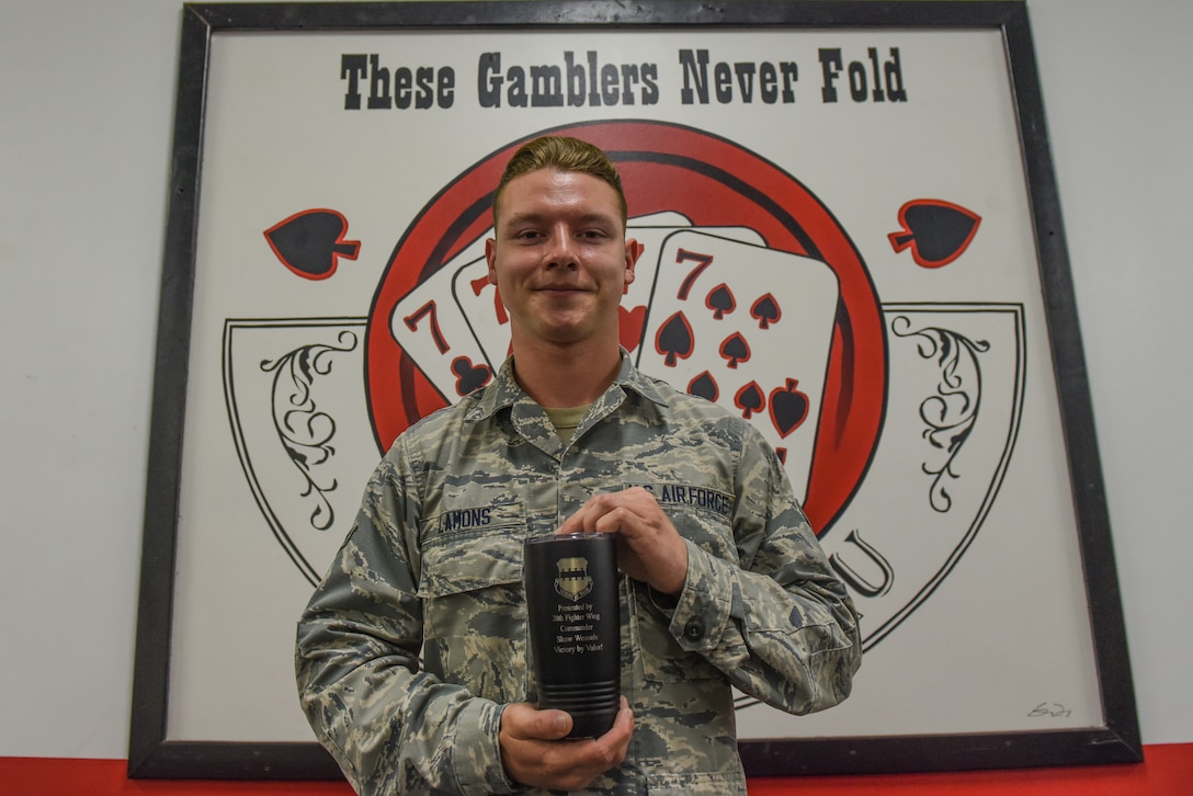 Airman 1st Class Jacob Lamons, 77th Fighter Generation Squadron assistant dedicated crew chief, holds his weasel mug at Shaw Air Force Base (AFB) South Carolina, July 20, 2020.