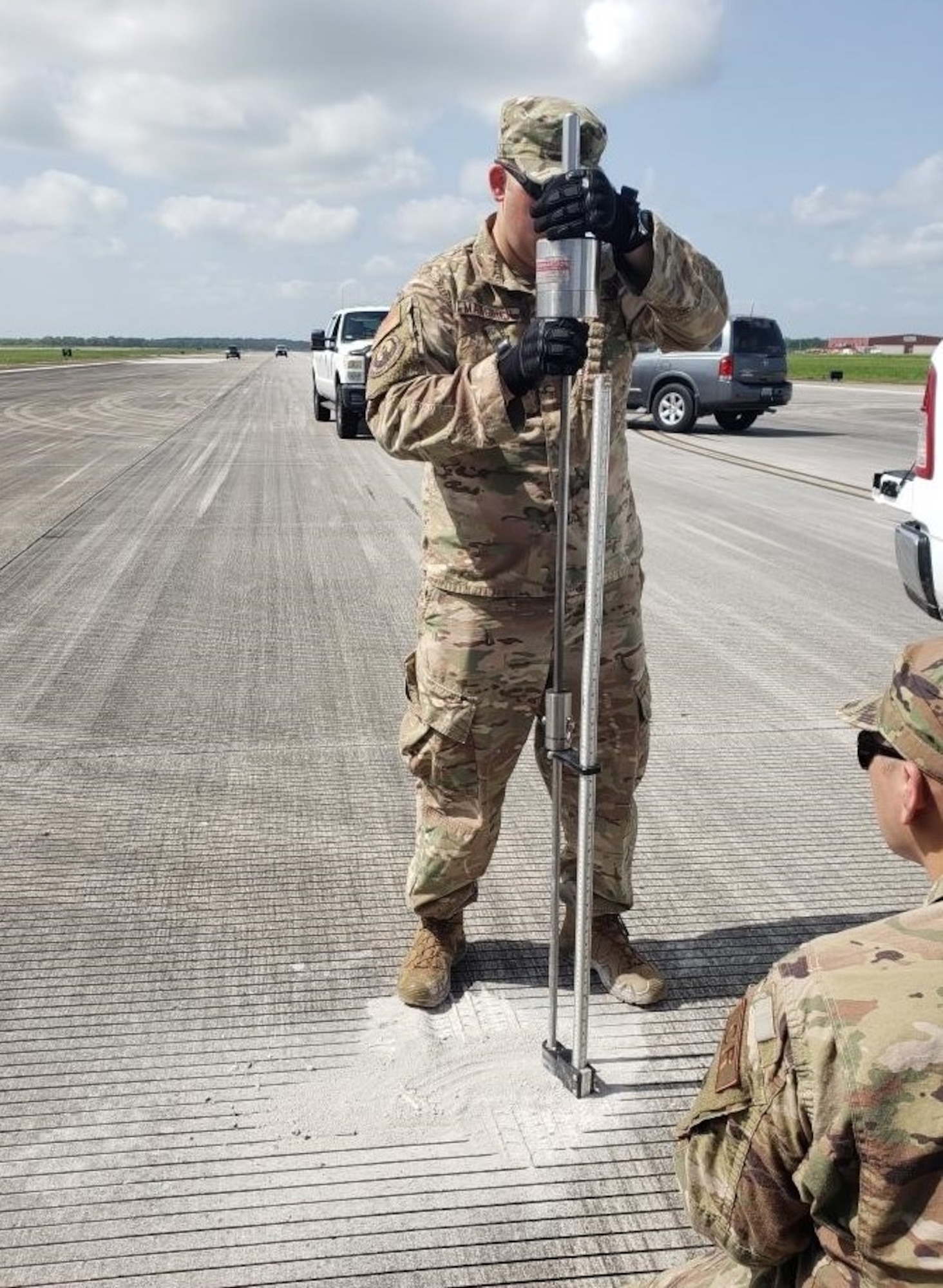 Maj. Zack Mangrich, 621st Mobility Support Operations Squadron air mobility liaison officer, performs a dynamic cone penetrometer test at Houma-Terrebonne Airport, Louisiana, July 11, 2020. Mangrich is part of an airfield assessment team tasked by Air Mobility Command to help the Defense Support for Civil Authorities prepare for hurricane season. (U.S. Air Force photo by Tech. Sgt. Luther Mitchell Jr)