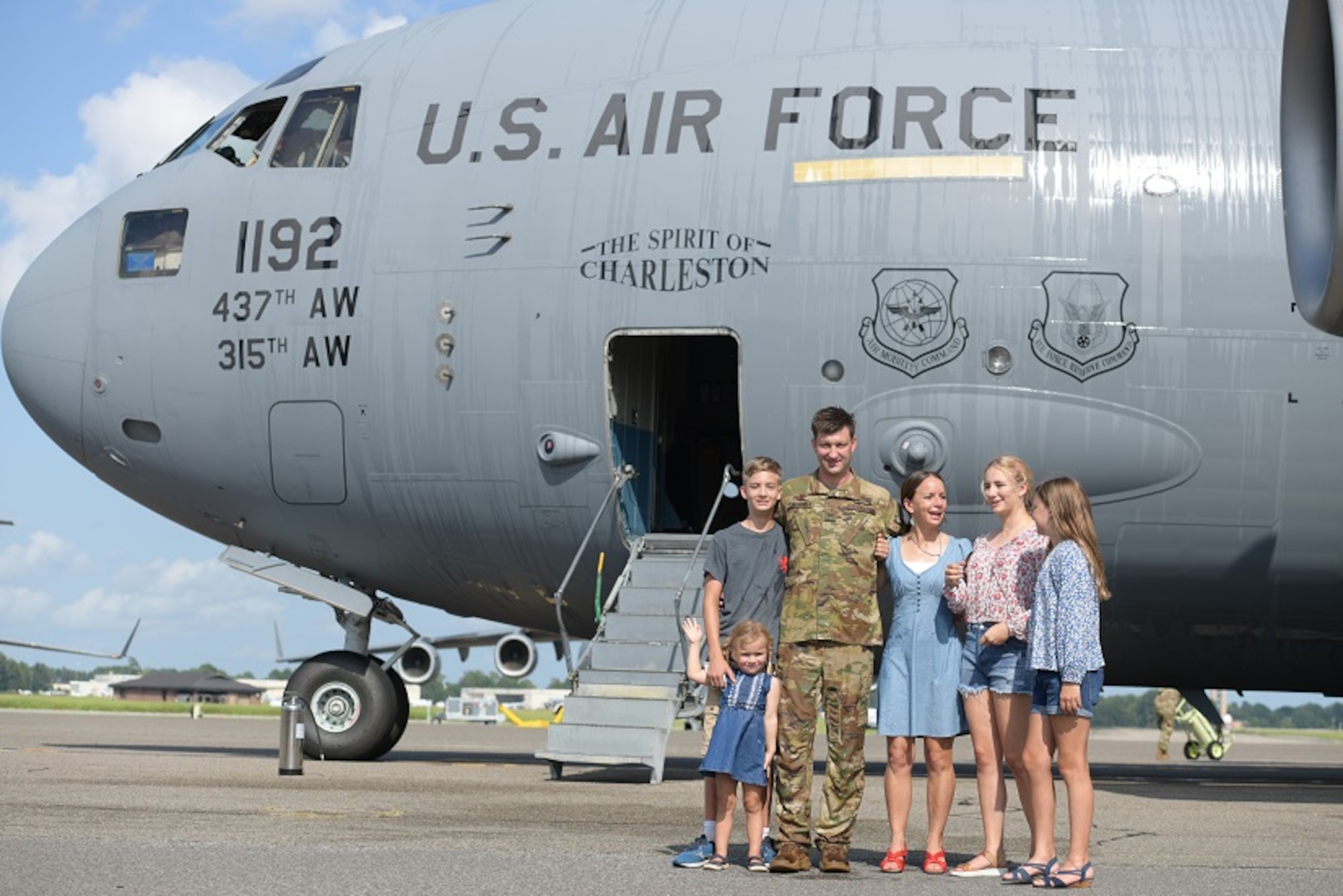 Col. Clinton ZumBrunnen, 437th Airlift Wing commander, and his family pose for a portrait after his fini flight as Airmen at Joint Base Charleston, S.C., Aug. 4, 2020. The fini flight is a military aviation tradition which marks a pilot’s retirement from the Air Force. ZumBrunnen Served in the U.S. Air Force for 22 years and accumulated more than 3,000 flight hours as an aviator. (U.S. Air Force Photo by Senior Airman Joshua R. Maund)