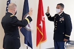Maj. Gen. Timothy P. Williams, the Adjutant General of Virginia, administers the oath of office to newly-promoted Maj. Waldon W. Jue Aug. July 30, 2020, in Fairfax, Virginia. (U. S. National Guard photo by Cotton Puryear)