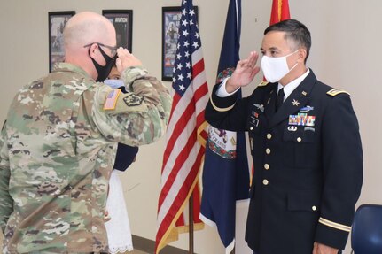 Maj. Gen. Timothy P. Williams, the Adjutant General of Virginia, administers the oath of office to newly-promoted Maj. Waldon W. Jue Aug. July 30, 2020, in Fairfax, Virginia. (U. S. National Guard photo by Cotton Puryear)