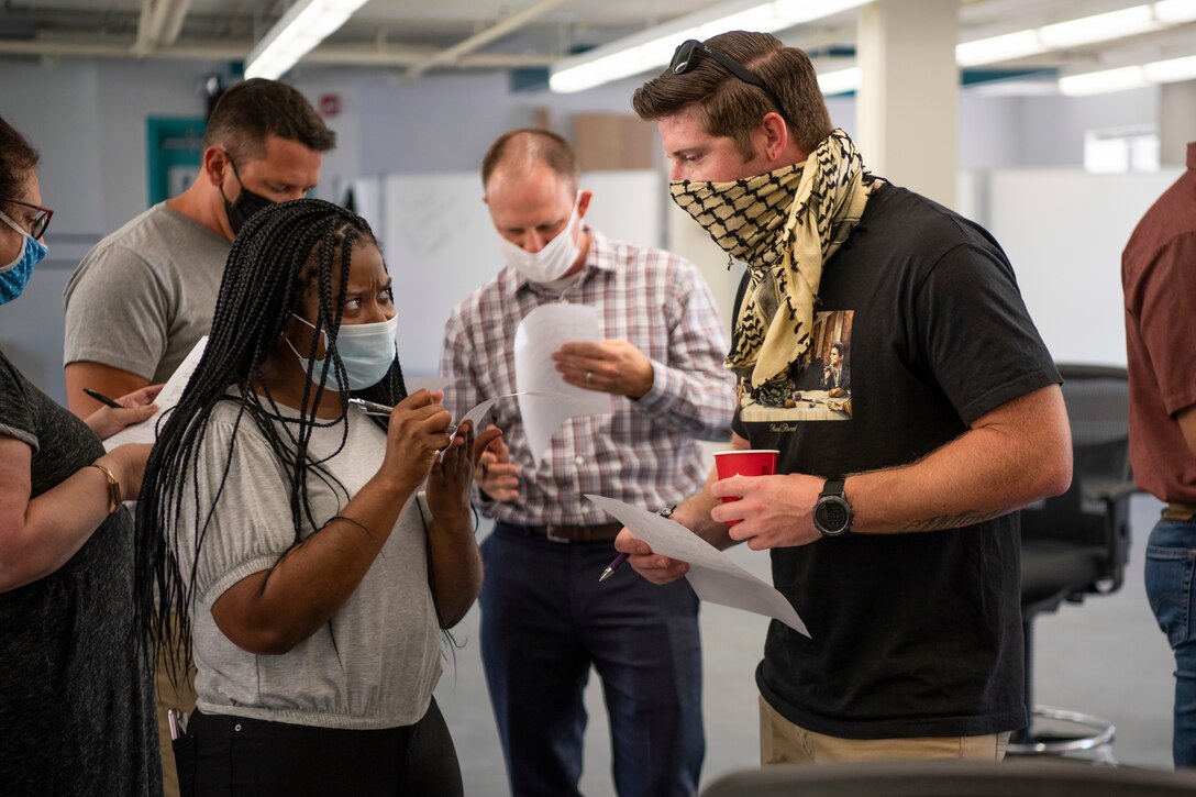 U.S. Air Force Airmen write on team-building exercise forms during a Pause for Race Relations event at Dover, Delaware, Aug. 5, 2020. A variety of events on base was scheduled Aug. 5-7 to create a safe and open environment for educating and allowing Airmen to express emotions on current events. (U.S. Air Force photo by Senior Airman Christopher Quail)