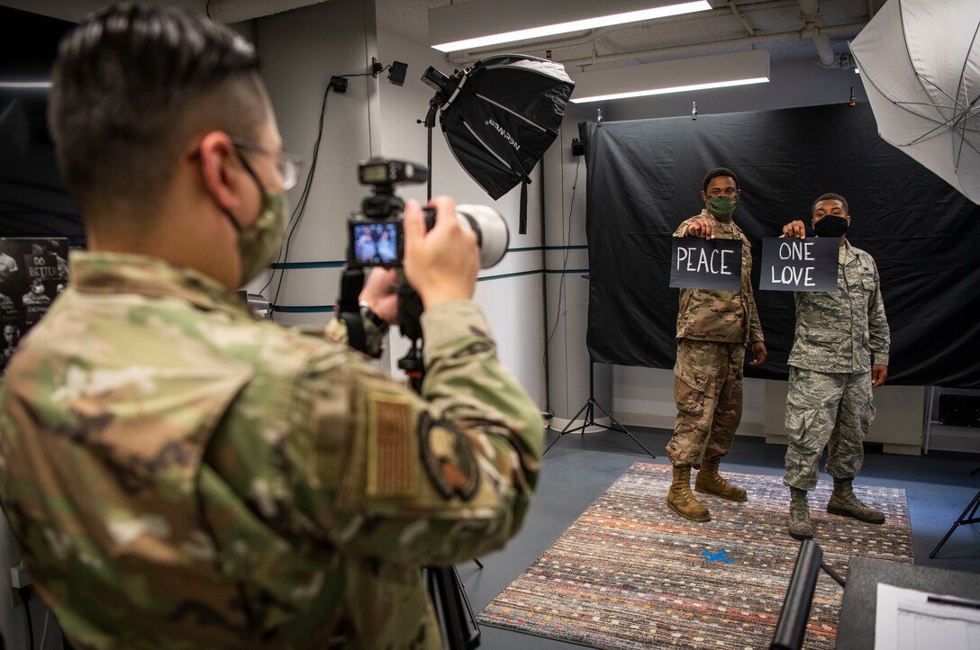 Maj. Jin Kim, a 436th Medical Support Squadron pharmacy flight commander, takes a photo of Airmen at a photo exhibit during a Pause for Race Relations event at Dover Air Force Base, Delaware, Aug. 7, 2020. A variety of events on base was scheduled Aug. 5-7 to create a safe and open environment for educating and allowing Airmen to express emotions on current events. (U.S. Air Force photo by Senior Airman Christopher Quail)