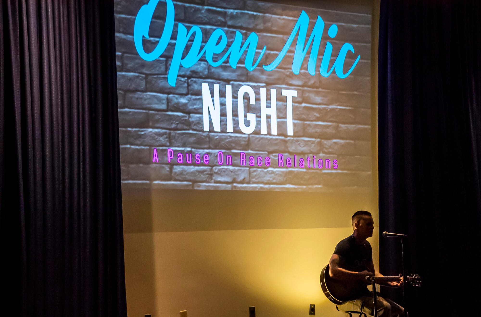 An Open Mic Night participant sings during a Pause for Race Relations event at Dover Air Force Base, Delaware, Aug. 6, 2020. A variety of events on base was scheduled Aug. 5-7 to create a safe and open environment for educating and allowing Airmen to express emotions on current events. (U.S. Air Force photo by Airman 1st Class Stephani Barge.)