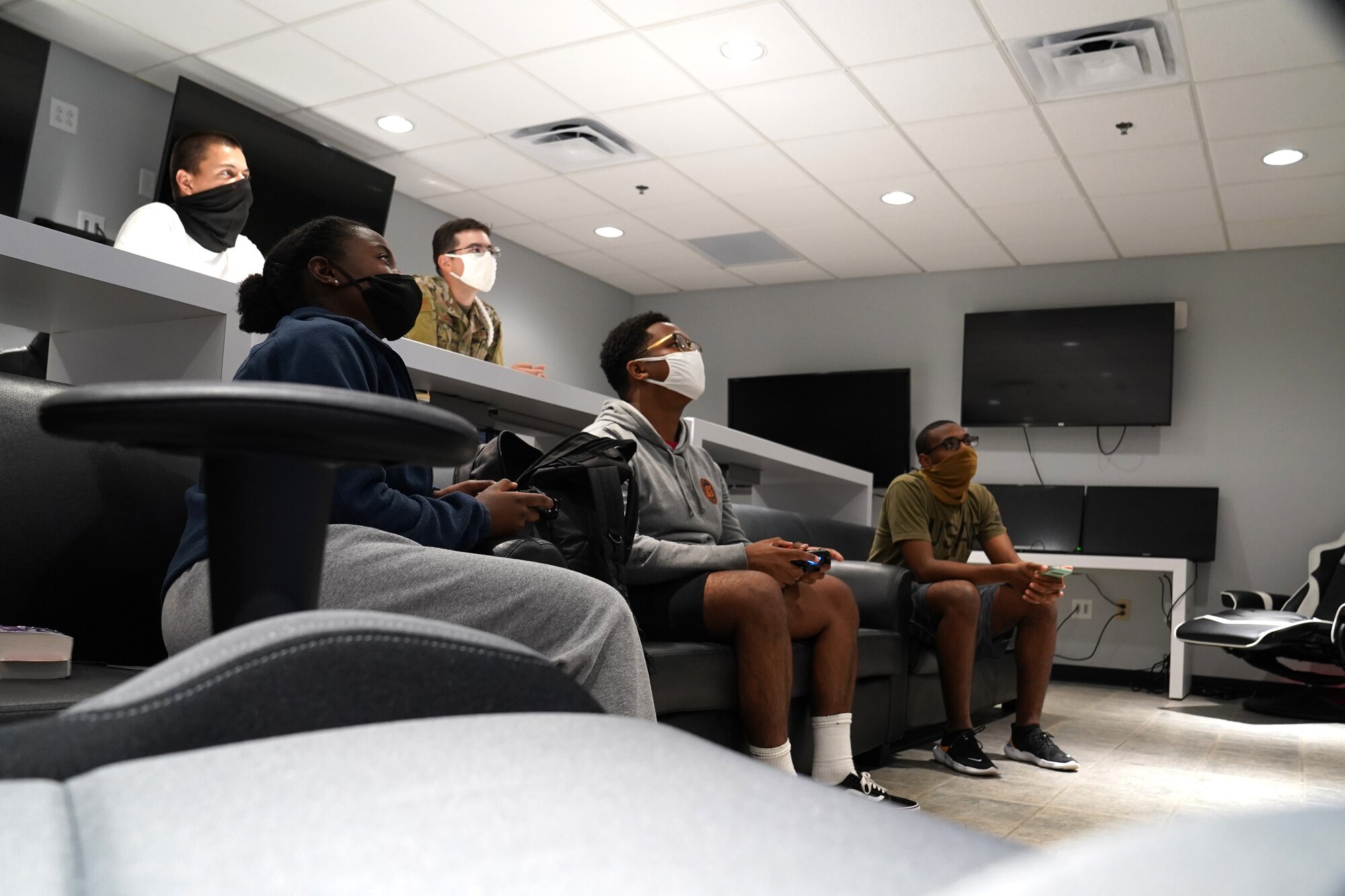 Students from the 81st Training Group play and watch video games in the Fishbowl gaming room inside the Levitow Training Support Facility at Keesler Air Force Base, Mississippi, Aug. 4, 2020. The 81st TRG put the gaming room together to give students the opportunity to interact and build friendships. (U.S. Air Force photo by Airman 1st Class Seth Haddix)