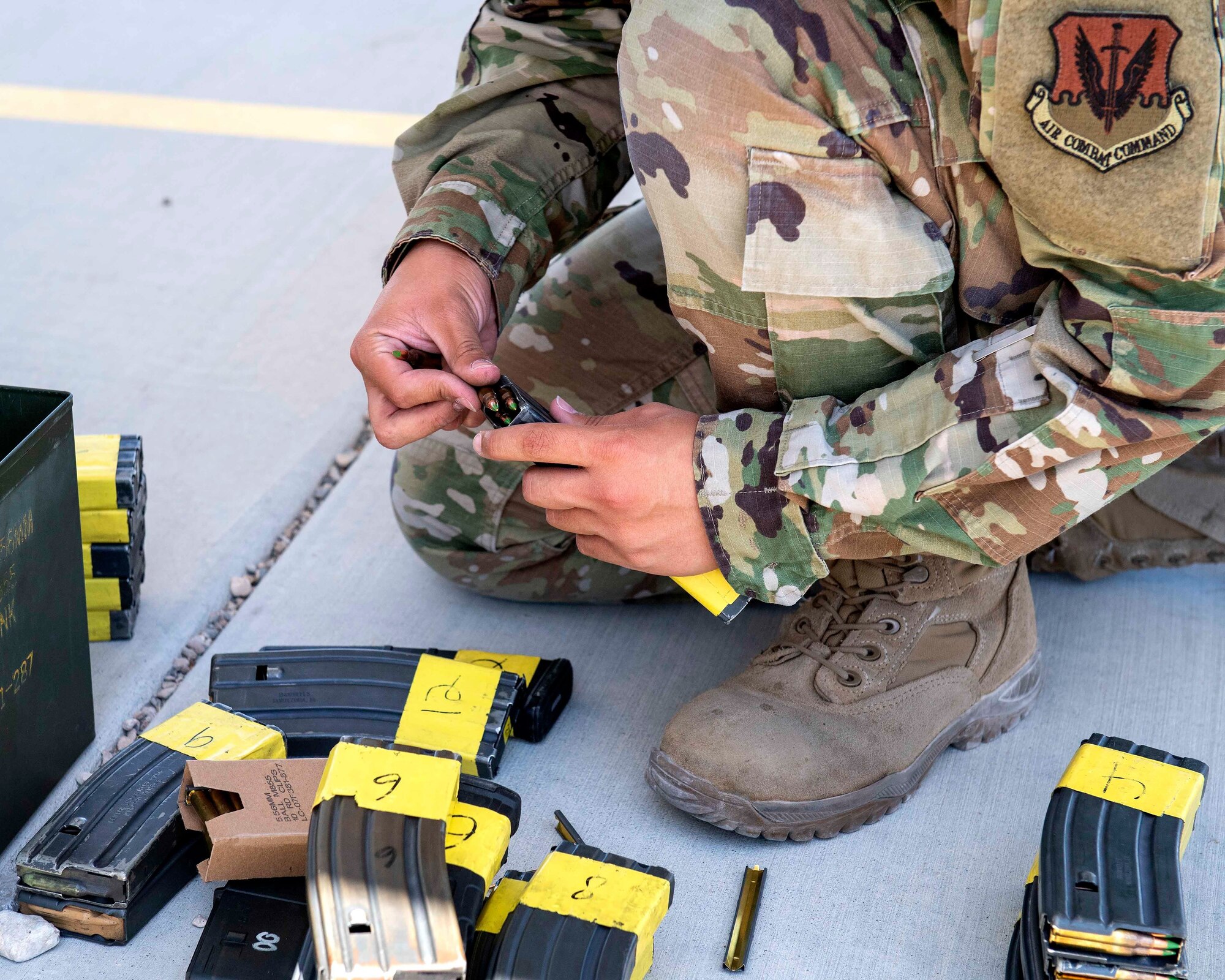 A male Airman student loads ammunition into an M4 carbine magazine