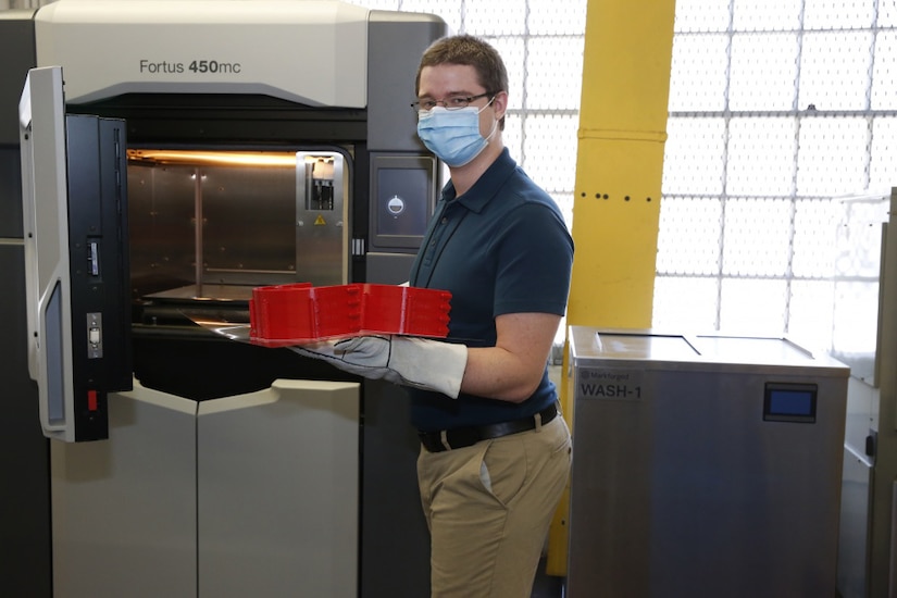 Employee shows a 3-D printed headband.