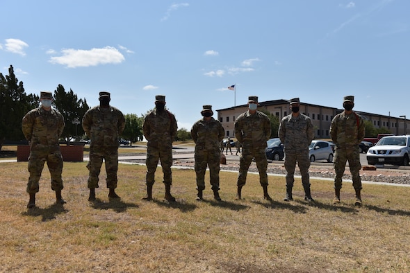U.S. Air Force Col. Angelina Maguinness, 17th Training Group commander, and Chief Master Sgt. Charmane Tatum, 17th TRG superintendent, stand with the Student of the Month winners outside of Brandenburg Hall at Goodfellow, Texas, Aug. 7, 2020. The Student and Rope of the Month awards are given to those students who have distinguished themselves in courses and by leading others. (U.S. Air Force photo by Staff Sgt. Seraiah Wolf)