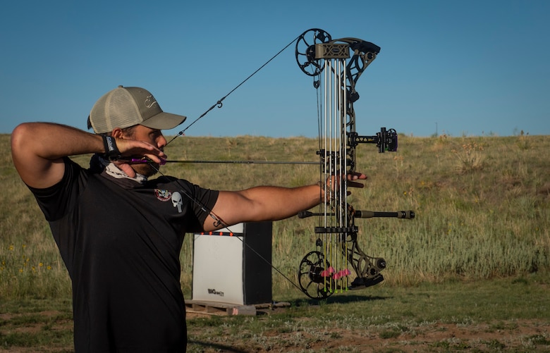 Alexander Nguyen, National Space Defense Center, draws a compound bow during an archery tournament, Aug. 7, 2020, at Schriever Air Force Base, Colorado. Nguyen came in second place, while Seth Cannello, 50th Force Support Squadron came in first in the competition. Participants who placed in first, second or third place won gift cards to a local archery shop. (U.S. Air Force photo by Cara Cannello)
