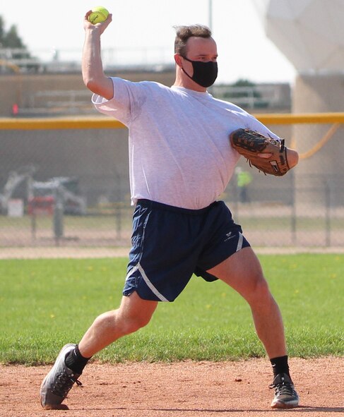 Trenton Harper, 50th Operations Support Squadron, prepares to throw the ball to first base Aug. 4, 2020 at Schriever Air Force Base. Players must wear a face covering while in the dugout but have the option to remove it while on the field. (U.S. Air Force photo by Marcus Hill)