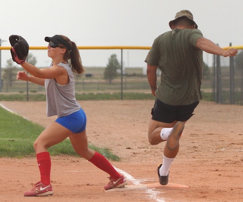 Janelle Rogers, 4th Space Operations Squadron, waits for the ball in attempt to get an out at first base Aug. 4, 2020 at Schriever Air Force Base, Colorado. The 4th SOPS nearly mounted a comeback against 50th Security Forces Squadron after trailing 7-0. (U.S. Air Force photo by Marcus Hill)