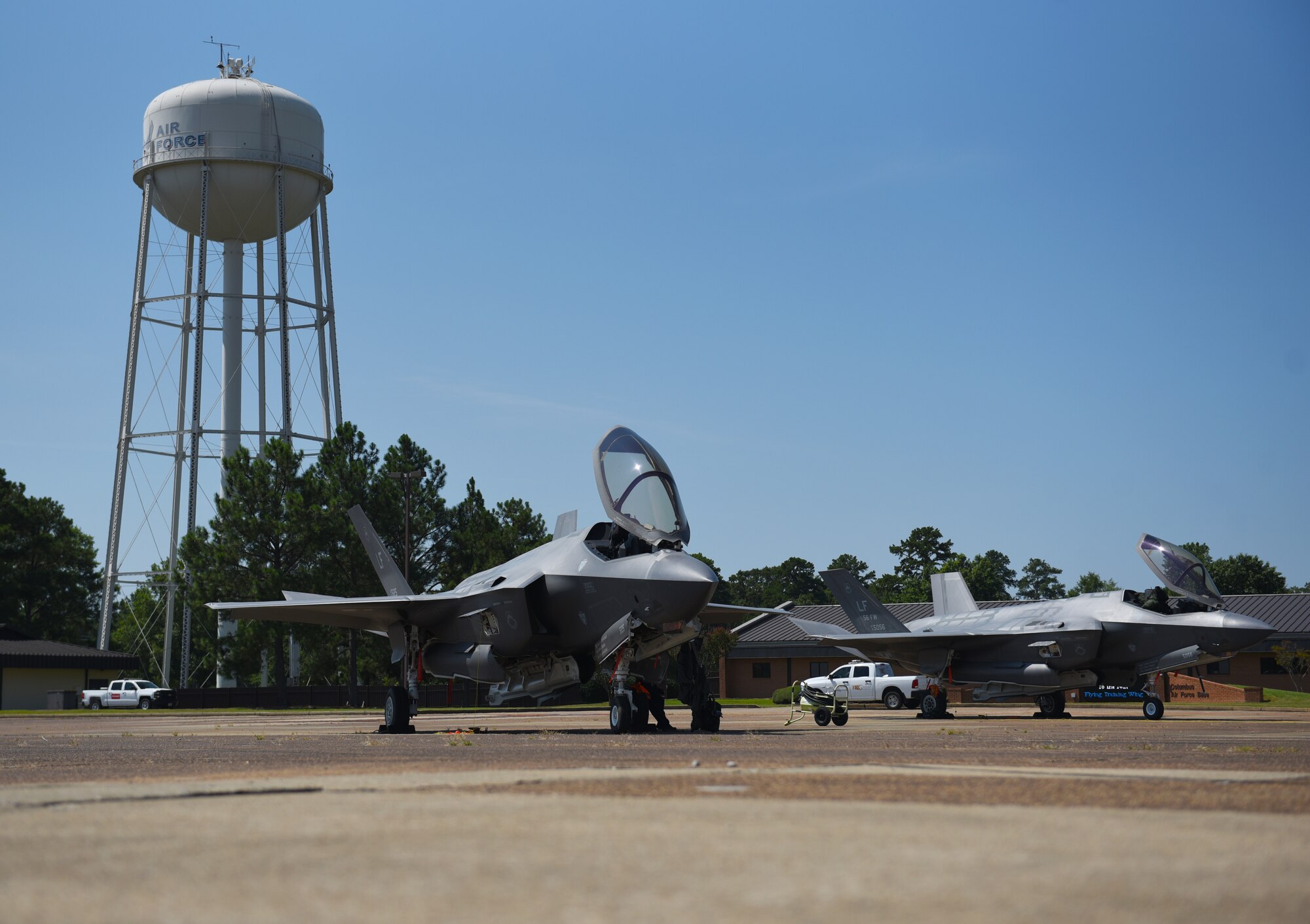 Two F-35A Lightning IIs sit on the flightline at Columbus Air Force Base, Miss. The F-35 is an agile, versatile, high-performance, 9g capable multirole fighter that combines stealth, sensor fusion and unprecedented situational awareness. (U.S. Air Force photo by Senior Airman Jake Jacobsen)