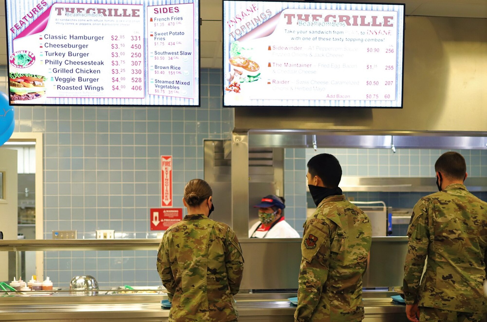 Students line up for lunch at the grille station inside the newly reopened The Beachcombers dining facility at Vandenberg AFB, California, Aug. 6, 2020.