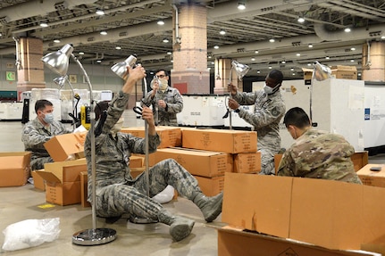 An image of New Jersey National Guardsmen building lamps for a Federal Medical Station at the Atlantic City Convention Center.