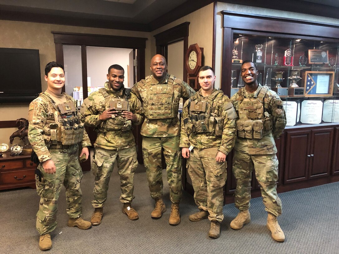 1st Lt Kojiro Kobayashi, left, poses for a photo with security forces airmen and Chief Master Sgt. Ronald Harper, 341st Missile Wing command chief, center. Kobayashi is one of four 20 AF nominees to AFGSC for the 2020 Lance P. Sijan Leadership Award. (U.S. Air Force photo)