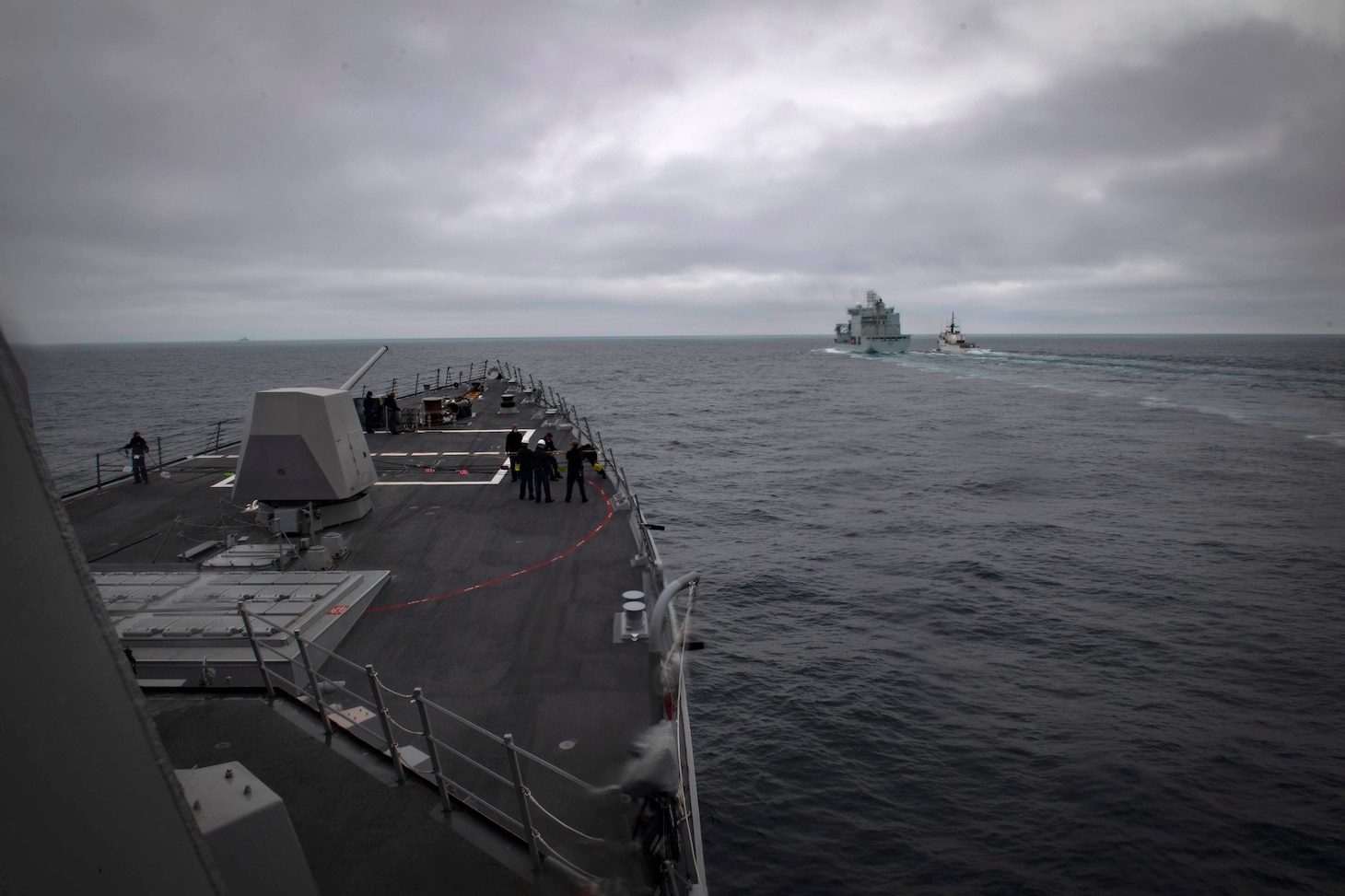 The Arleigh Burke-class guided-missile destroyer USS Thomas Hudner (DDG 116) moves alongside Royal Canadian ship MV Asterix during a replenishment-at-sea approach drill between the U.S. Coast Guard, US Navy and Royal Canadian Navy, Aug. 5, 2020.